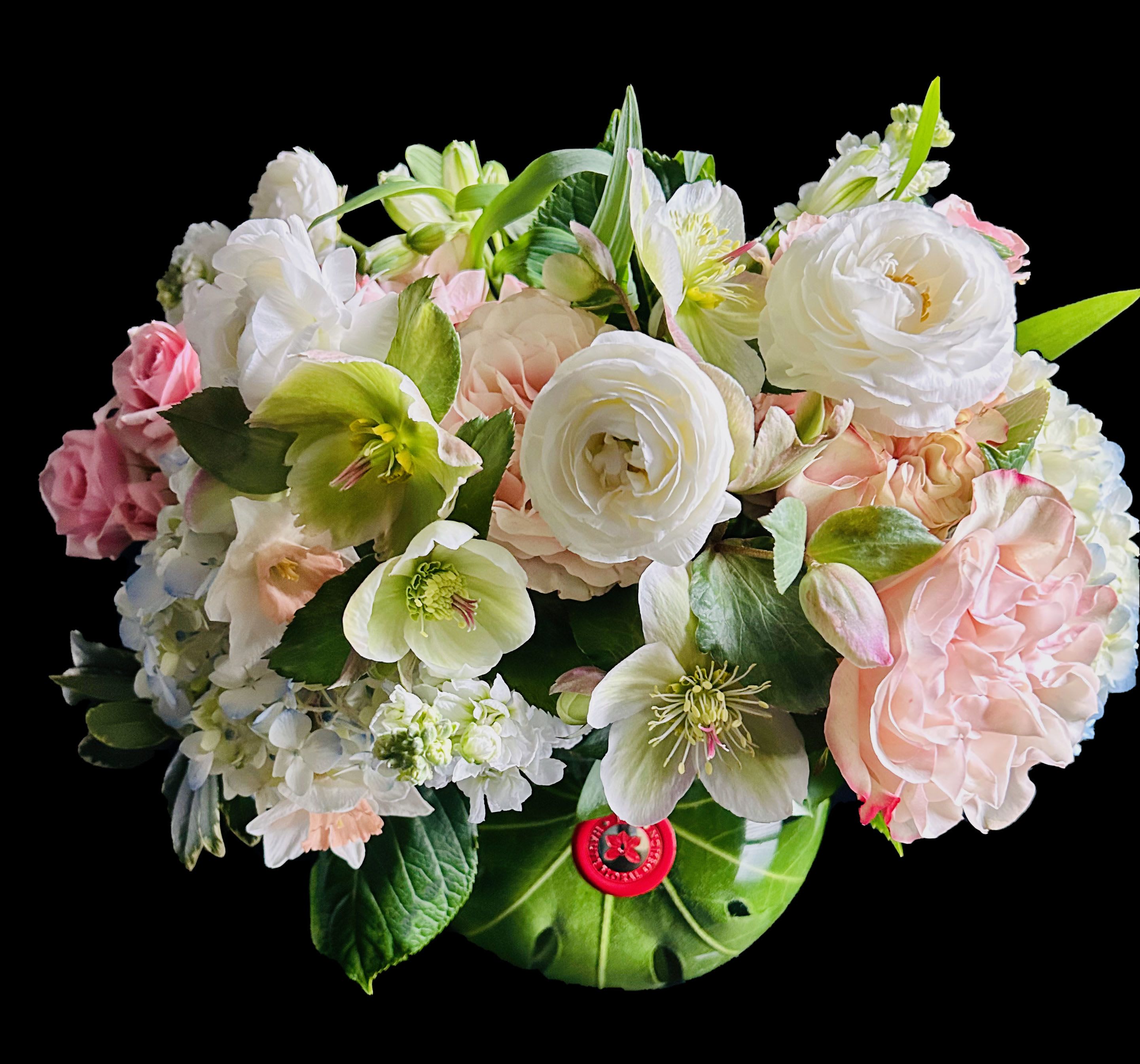 Pastel bouquet of white and pink flowers in a green vase