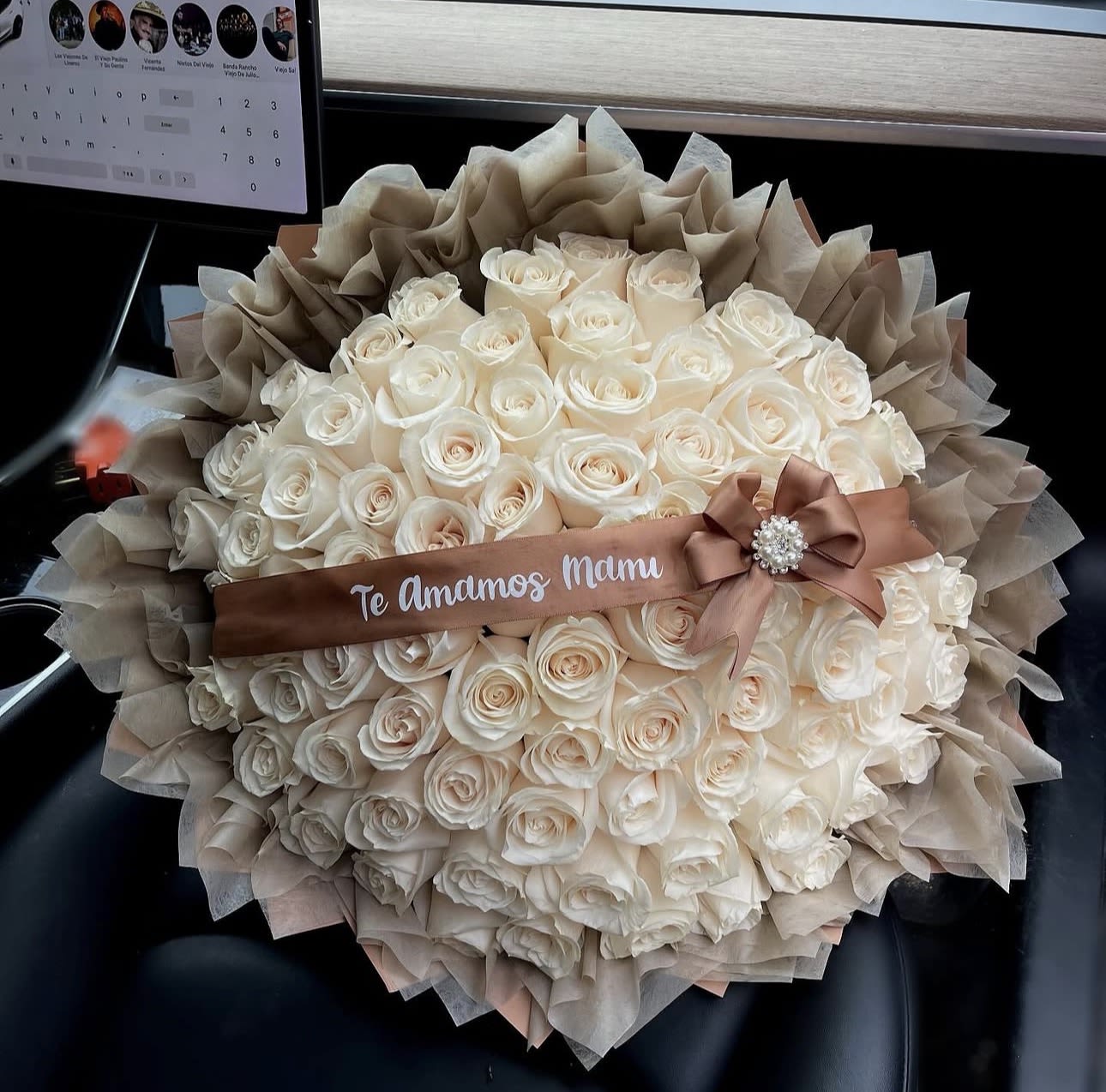 El amor puro de mama  - Cream-to-blush roses form a lavish, dome-shaped bouquet that reads like a quiet love letter - the perfect Mother's Day or anniversary roses to make the person you're thinking of feel cherished. El amor puro de mama pairs soft white and peach blooms in a tightly packed, rounded silhouette that gives an immediate impression of warmth and devotion.  Wrapped in layered taupe and beige decorative paper and finished with a brown satin ribbon and rhinestone brooch, this arrangement balances romantic softness with elegant formality. The dense rose heads create a creamy texture and gentle scent, while the neutral wrap keeps the focus on the roses' subtle color gradation. Sized as a large, full bouquet, it arrives ready to display and is an unmistakable gesture of love and appreciation.  Ideal for a mother, partner, or anyone who deserves a heartfelt celebration, this bouquet speaks of tenderness and long-lasting affection. Order with confidence for special occasions like Mother's Day or anniversaries - the structured dome and secure wrap make delivery and display simple, so she'll feel truly seen from the moment it's unwrapped.