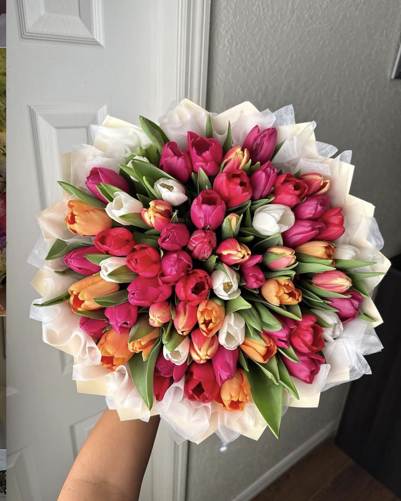 She loves Tulips  - A bright, hand-tied tulip bouquet that says "she loves tulips" the moment she sees it-perfect as a birthday bouquet, spring celebration gift, or a romantic gesture. The mix of vivid pink, coral-orange and crisp white tulips creates an energetic, joyful impression that will make the person you're thinking of feel noticed and celebrated.  This arrangement is densely packed and rounded, with layered tulip heads and long green leaves for fresh contrast. Finished in soft white decorative paper wrap, the bouquet has a polished, gift-ready look that reads both casual and thoughtful. Ideal for everyday gifting or seasonal occasions, the tulips arrive ready to display-trim stems and refresh the water to keep blooms lively for several days.