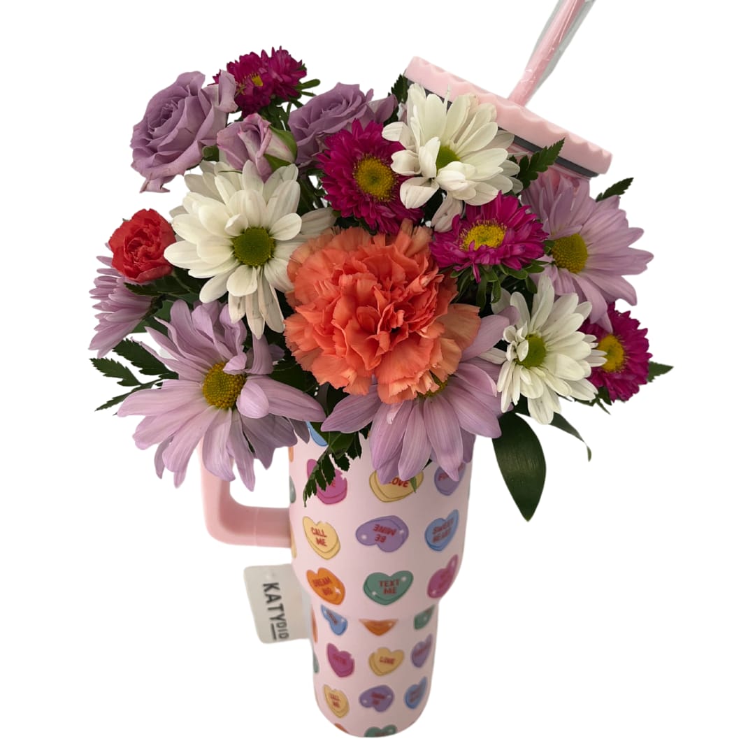 Conversation Cutie Tumbler Arrangement - Tumbler featuring color coordinating flowers including roses, carnations, daisies, and statice. Flowers subject to change upon availability but color palette will remain the same! 40 ounce stainless steel tumbler Includes reusable plastic straw All-day chill or heat Dishwasher safe Screw-on plastic top with straw opening Adjustable straw cover for easy travel Easy-to-hold handle Fits in car cup holder