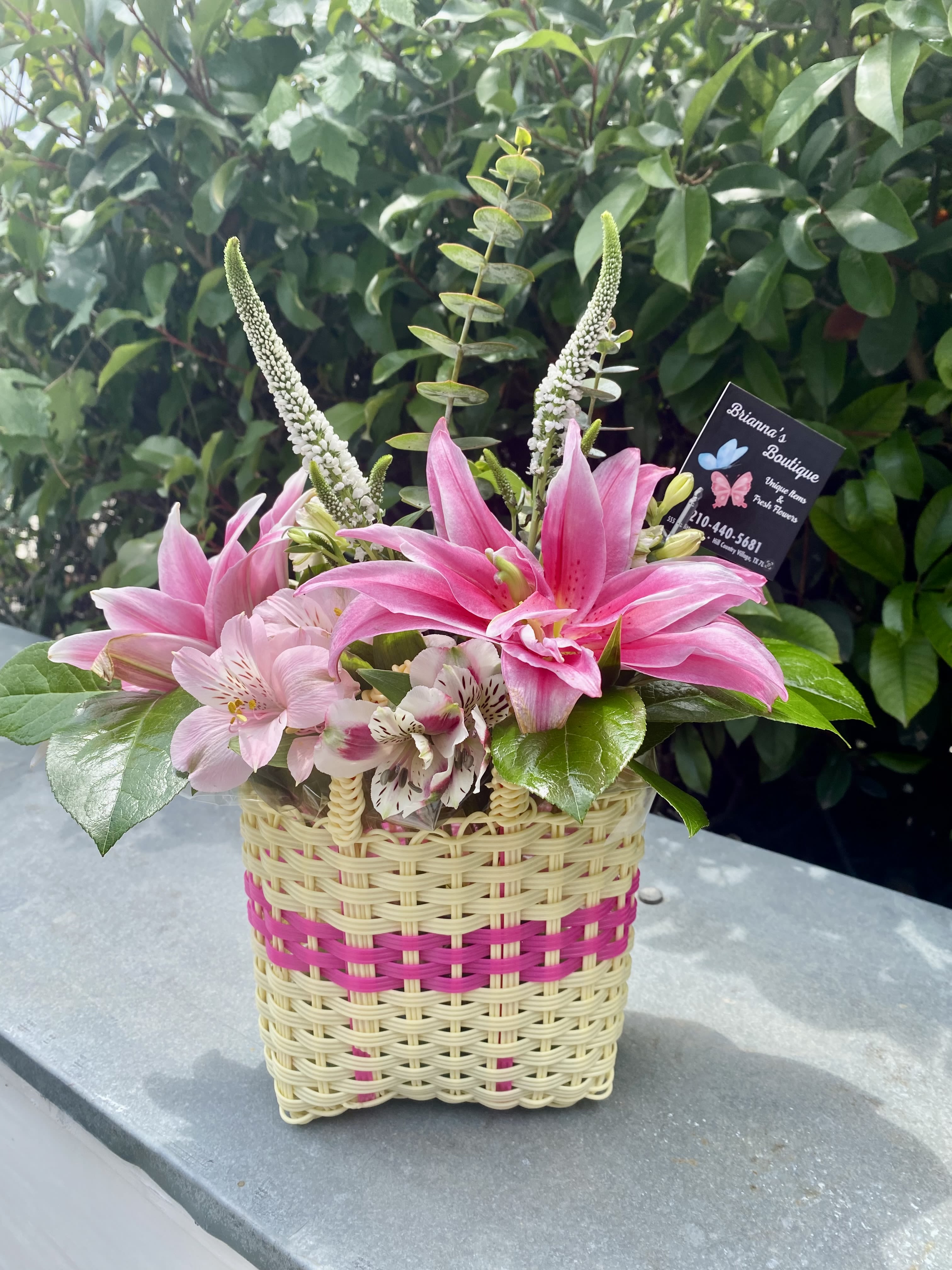 Pink lilies and alstroemeria in a woven basket