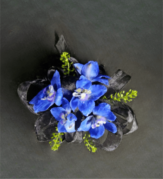 Northmont Dark Blue Delphinium Corsage - A naturally blue flower that will compliment any outfit. The only flower color option for this boutonniere is dark blue. Please select the wristlet color and up to 2 ribbon colors from the add-on selections you would like included. (Please do not select any of the flower color options)