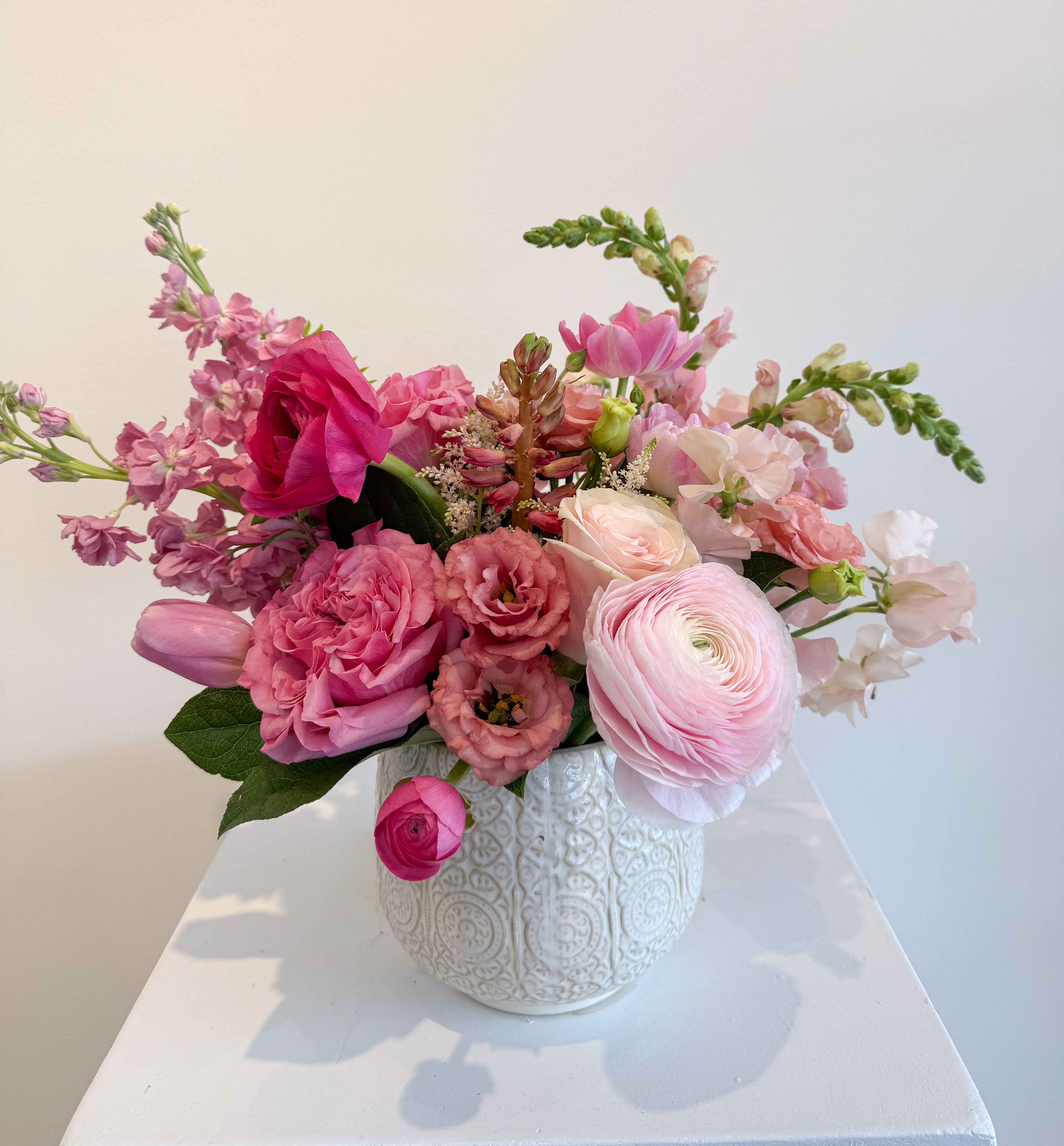 Sweetest Devotion  - A monochromatic Mother’s Day arrangement designed to celebrate our moms all month long. This month’s special honors the nurturing, loving, feminine queen in all of us—what better color than pink?  Featuring a romantic mix of soft to bold blush tones, this design embraces all shades of pink in an airy, undone, whimsical style that feels effortless, elegant, and full of heart, just like mom!  LIMITED ADDITION ADD ON for $30 - under "make it special":  Enhance your arrangement with a charming bud vase featuring three to four fresh blooms. Each vase will be thoughtfully designed in either pink glass or pink ceramic, making it a sweet and stylish complement.  It’s a simple, adorable way to add something extra for the moms who deserve it all!!  Perfect for a little added love from kids or even furry family members.  