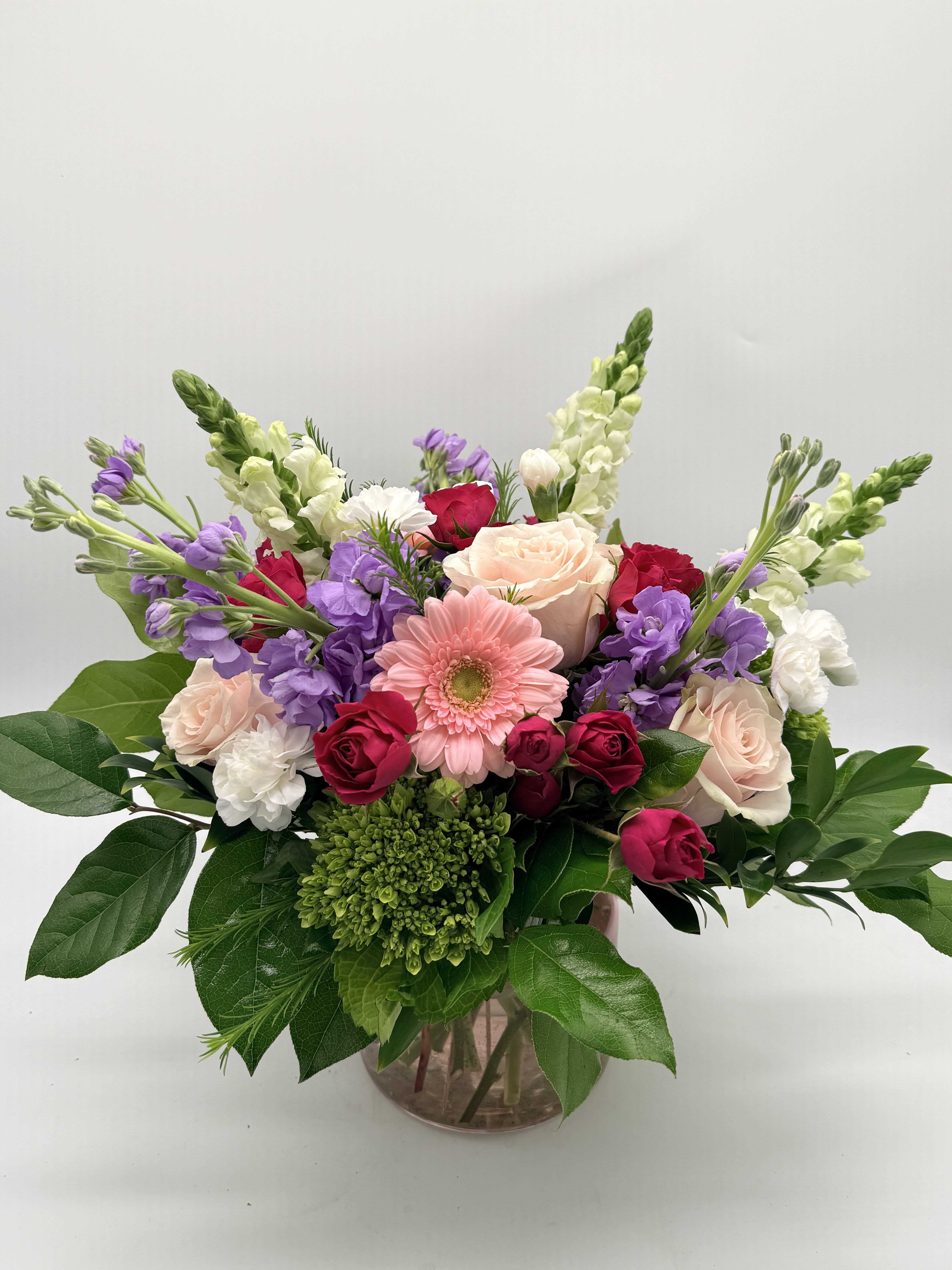 Sweet Dreams  - A dreamy mix of blooms designed in a delicate pink vase.   Shades and flowers may vary. 