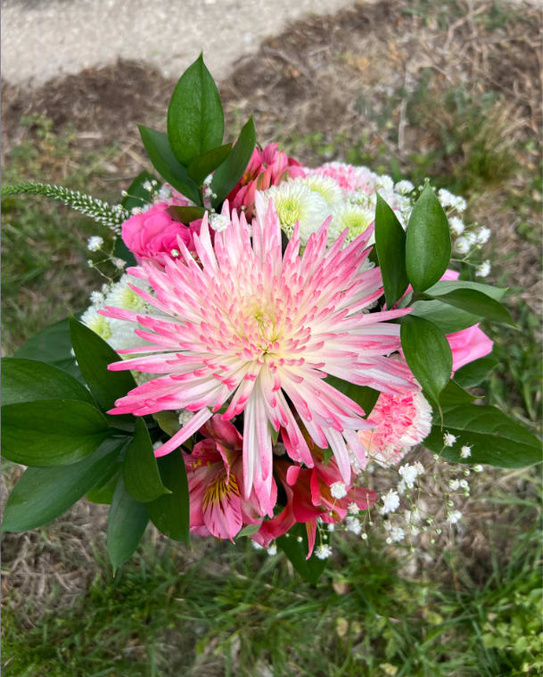 Northmont Shades of Pink Handheld Bouquet - An elegant hand-tied bouquet that will compliment any prom outfit. Filled with mixed flowers such as roses, daisies, and alstroemeria. *Vase not included*