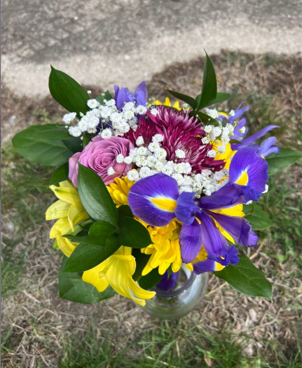 Northmont Yellow, Purple &amp; Blue Handheld Bouquet - An elegant and colorful hand-tied bouquet that will compliment any prom outfit. Filled with mixed flowers such as roses, daisies, and iris. *Vase not included*