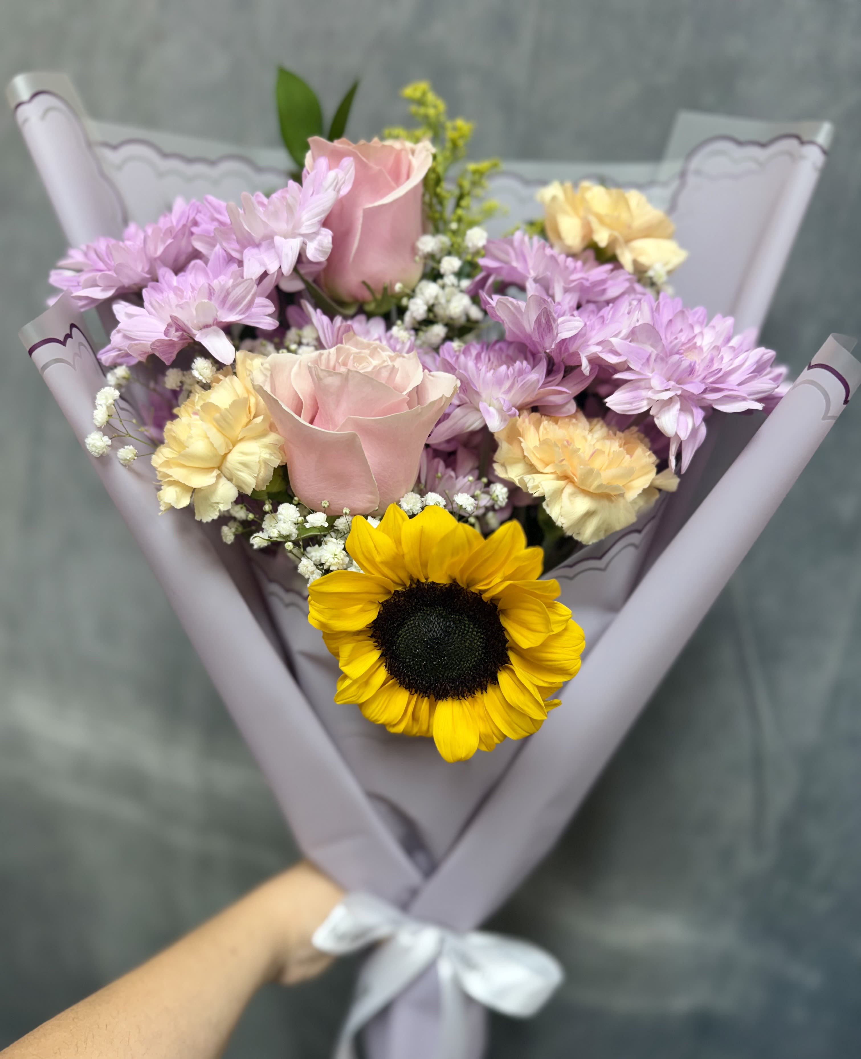 Lavender sunshine bouquet - A delightful fusion of sunny vibrancy and lavender tones with pink toned flowers ideal for bightening up any space or special moment.