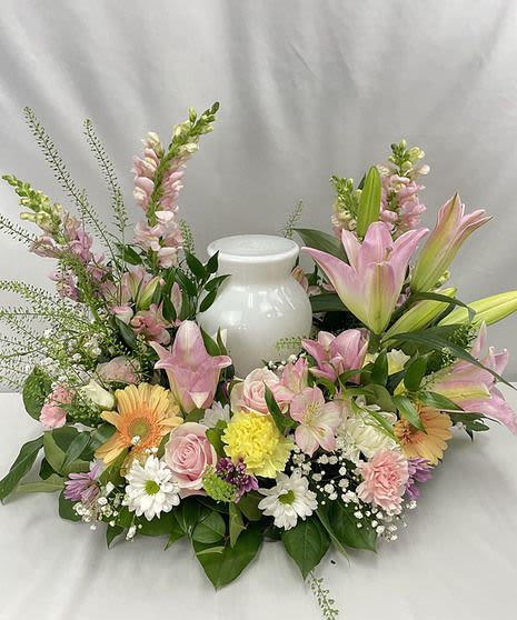 Peaceful Embrace Cremation Arrangement - This arrangement is meant to provide a soft final embrace to a loved one, with the flowers representing inner strength and restored innocence of the soul.
