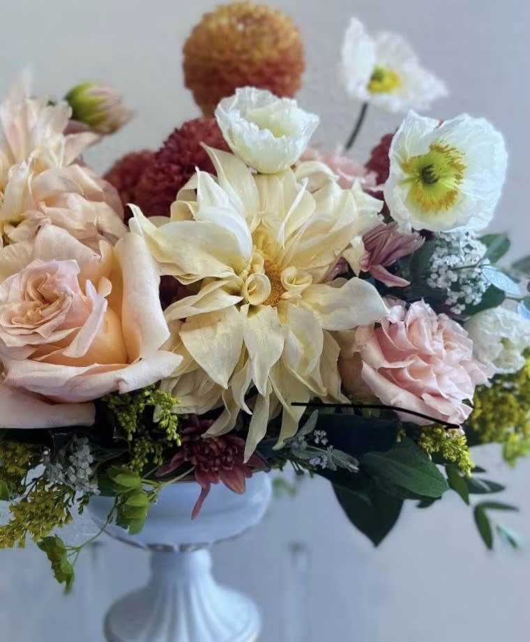 Golden Honey - A warm, honey-toned composition layered with soft apricot, golden ochre, and muted blush florals. Designed with natural movement and rich texture, this arrangement captures the glow of late afternoon light—sunlit, romantic, and quietly abundant.  An elevated take on a garden-inspired palette, Golden Honey Reverie brings depth and warmth while maintaining a refined, artful balance.  Note: Flower varieties may vary slightly based on seasonal availability while maintaining the overall color palette and design.