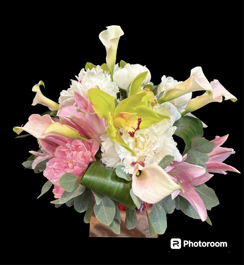 Bouquet of pink and white flowers with calla lilies in a box