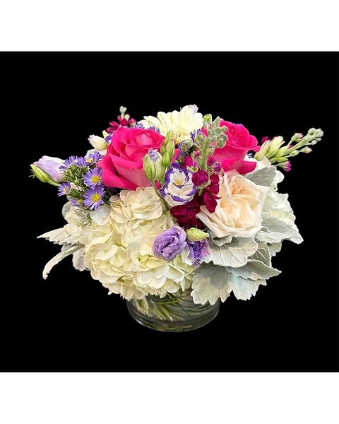 Bouquet of pink and white flowers in a clear glass vase