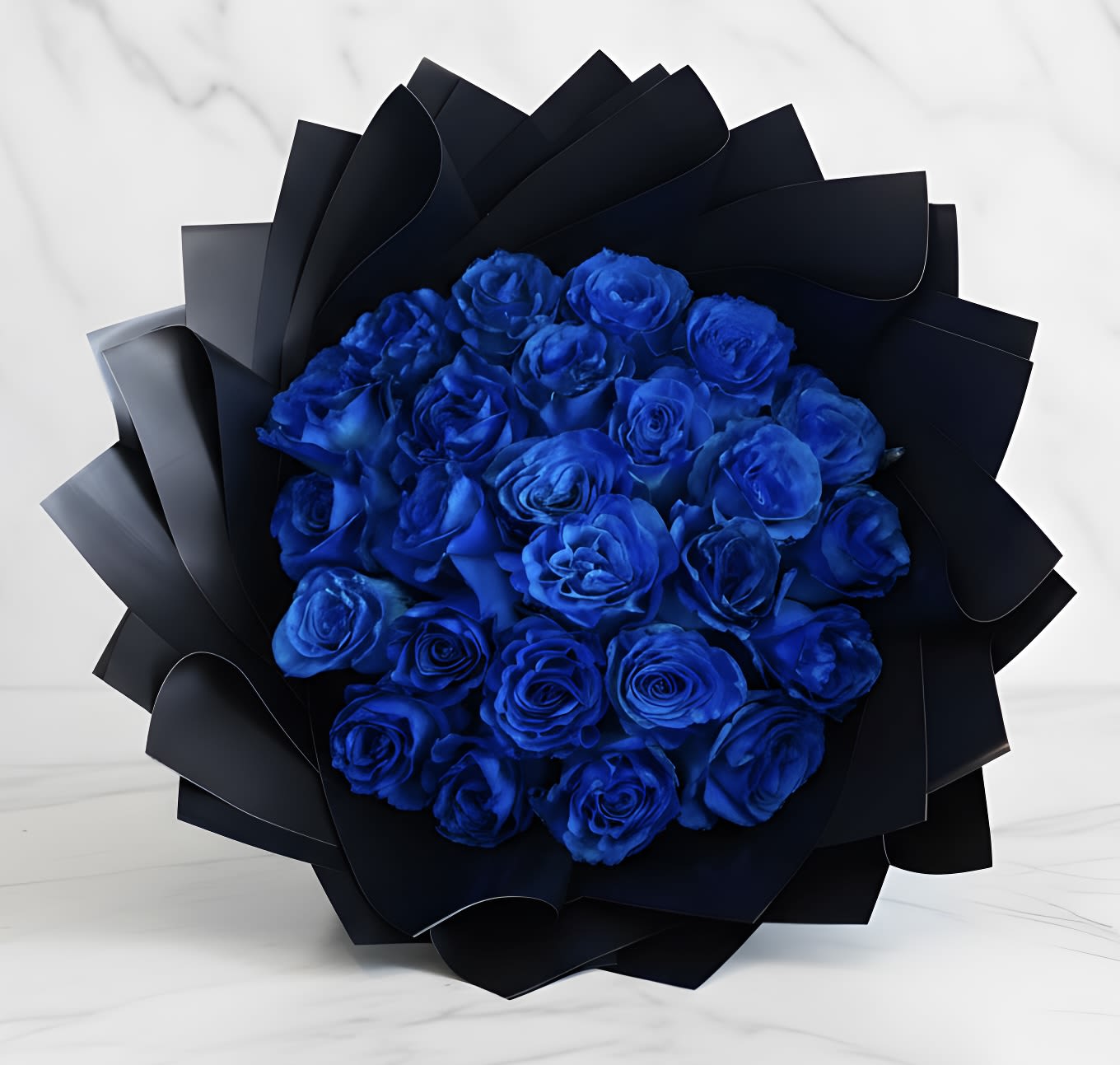 Bouquet of vivid blue roses wrapped in black paper