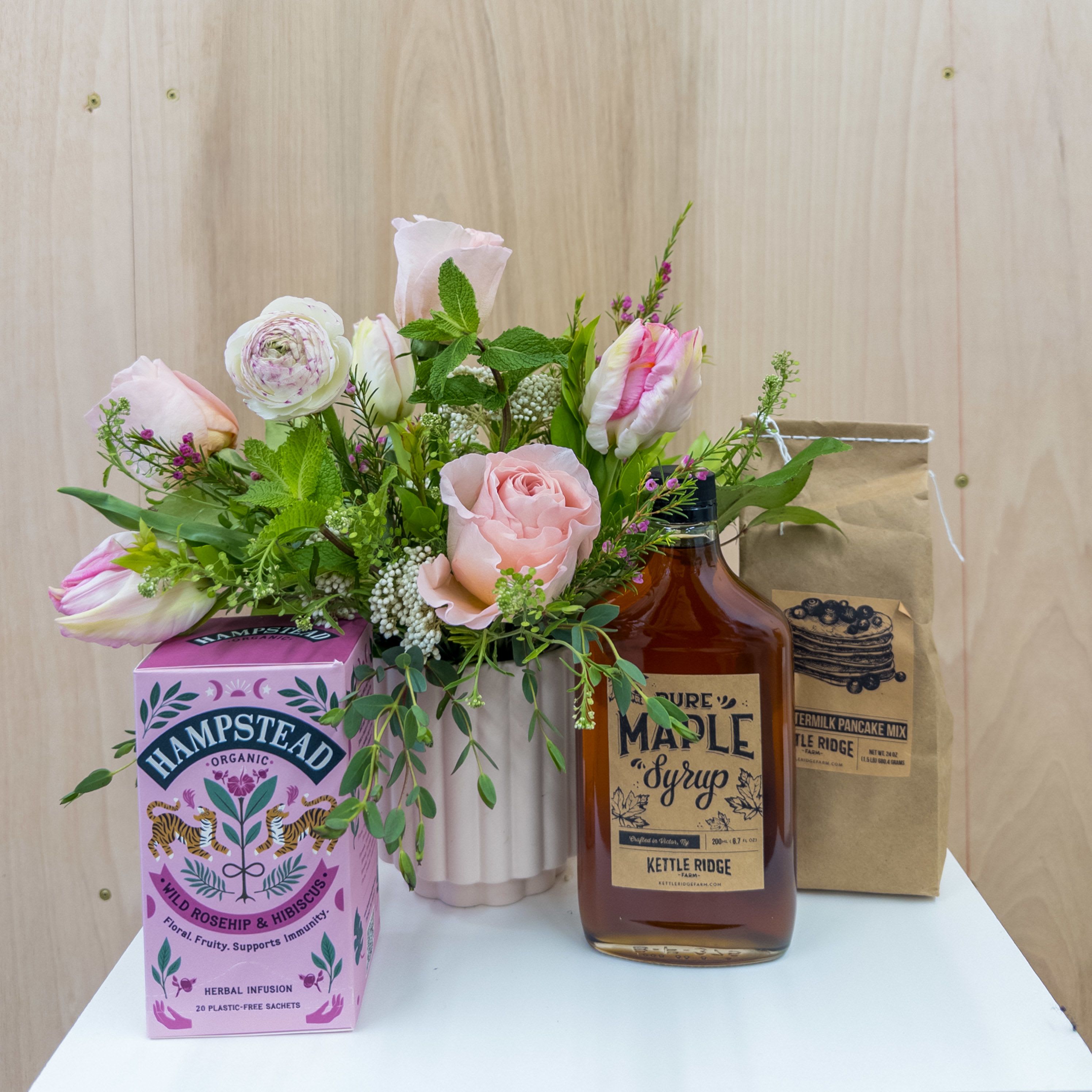 Breakfast in Bed - The gift of flowers AND breakfast? Yes, please. This gift set does it all to give someone a well earned break in the morning. Locally harvested maple syrup pairs with pancake mix and a tea blend to make beautiful pink flowers shine all that much more. Upgrade to deluxe and premium for additional blooms in the arrangement.