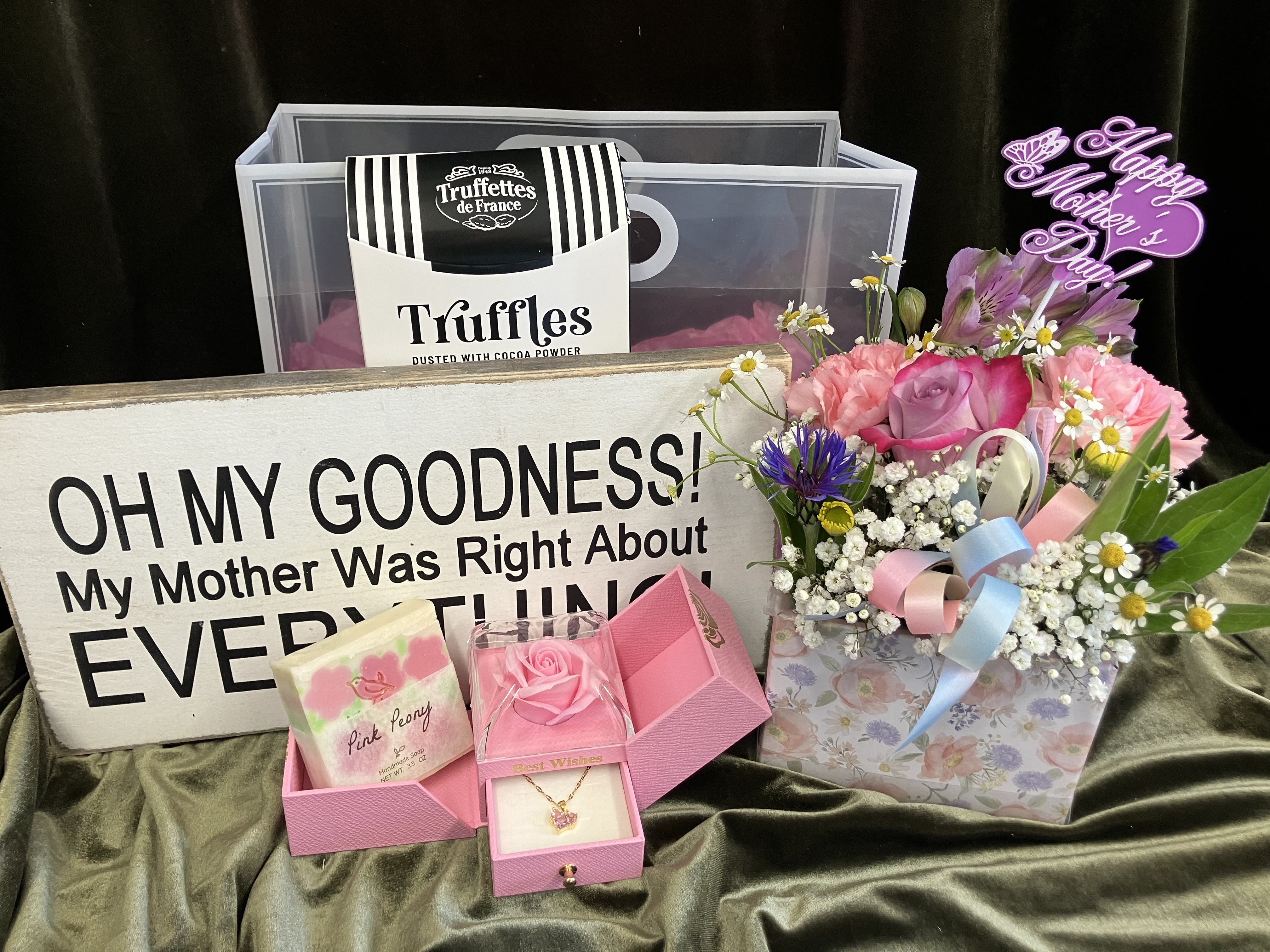 Mothers Day Day Grab Bag  - Carefully curated grab bag includes the perfect items for Mother’s Day. A fresh flower arrangement, locally made soap, a pink necklace, a fun shelf sight and chocolate truffles in a classy carry bag tied with ribbon. 
