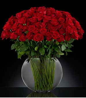 Large bouquet of red roses in a clear glass vase
