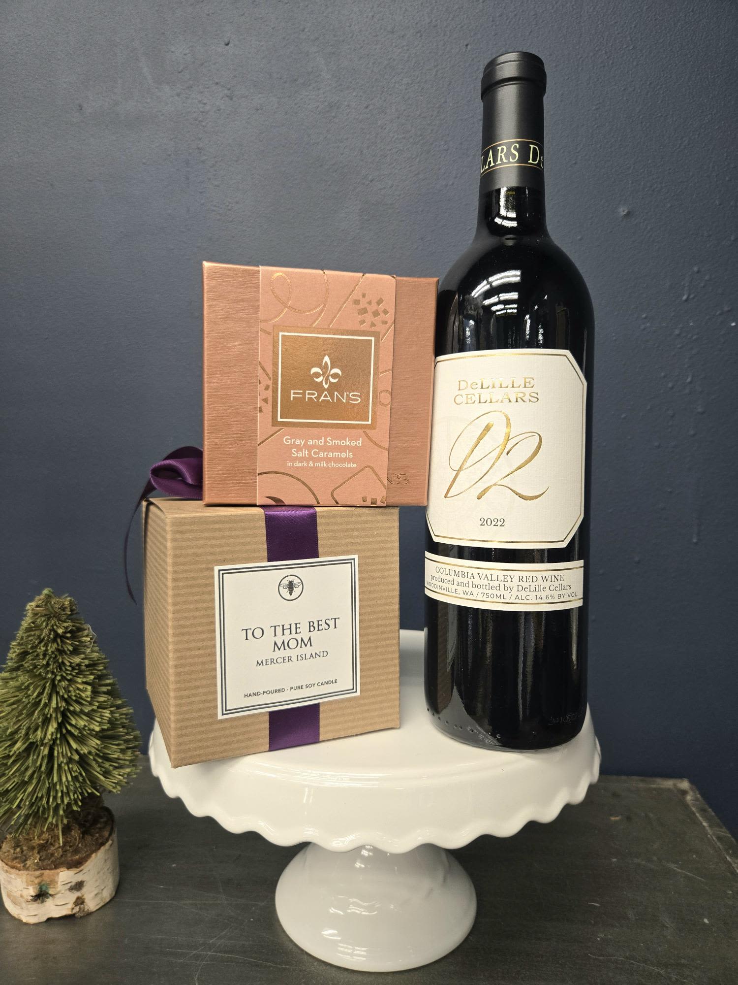 Mom's Little Joy Bundle - Celebrate Mom with a curated trio of D2 red wine by DeLille Cellars, a calming candle by Ella B. with a scent of lavender and cotton, and decadent gray and smoked salt caramels covered in dark and milk chocolate by Fran's.