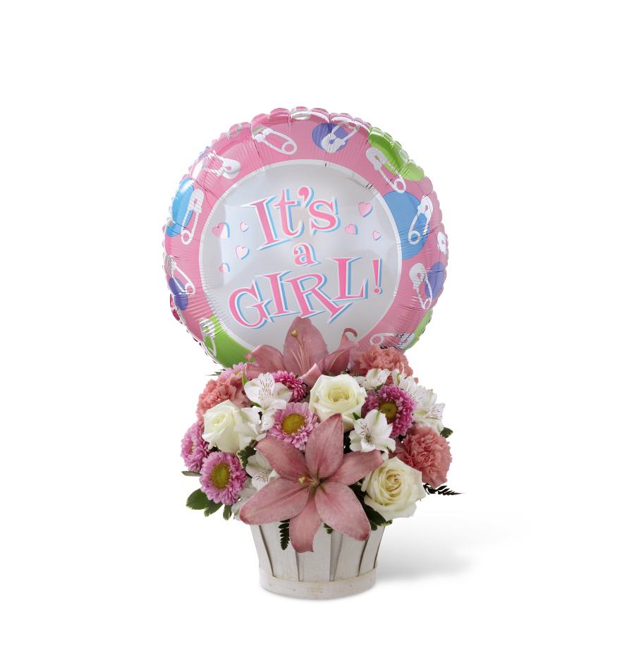 Pink and white flower arrangement with a "It's a Girl!" balloon