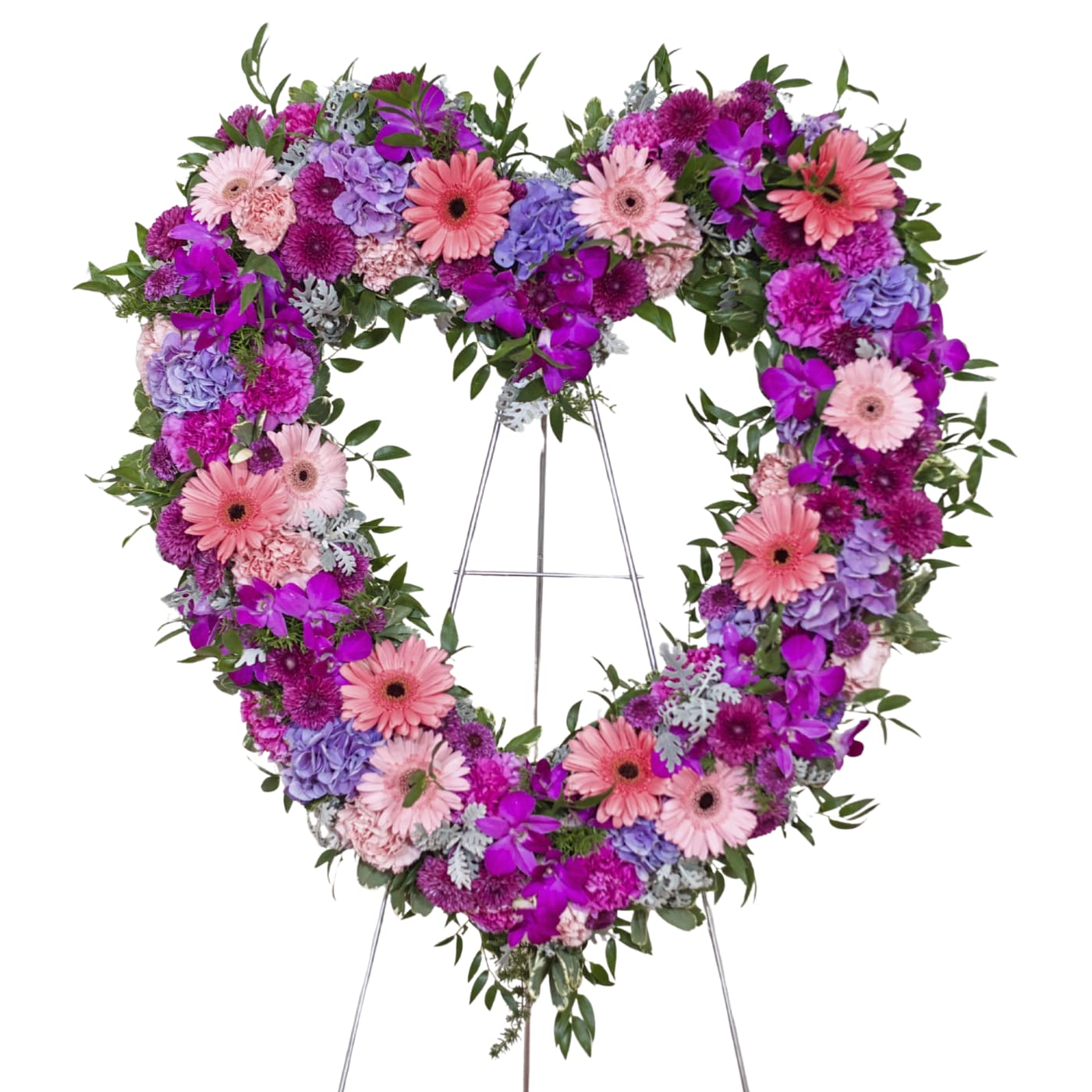 Heart-shaped floral wreath on a stand with pink, purple, and lavender blooms