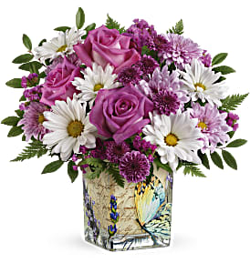 Pink roses and white daisies in a decorative square vase