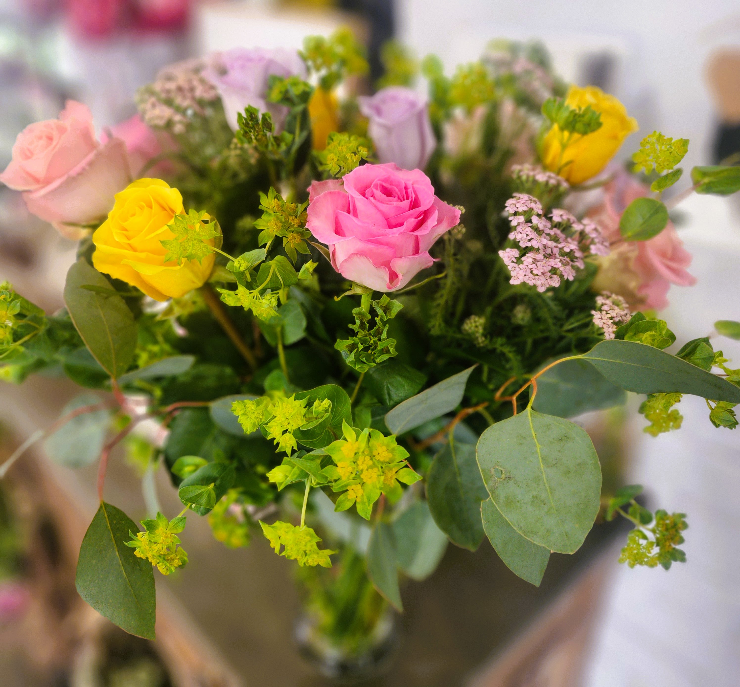 Colorful Rose - Mix Colorful Roses. Pink, Yellow, Purple, White, Red... All mix roses in a vase. One Dozen with Greenery and Filler in a tall clear vase (as Photo)  Deluxe: 18 Roses. Premium: 2 Dozen Roses.