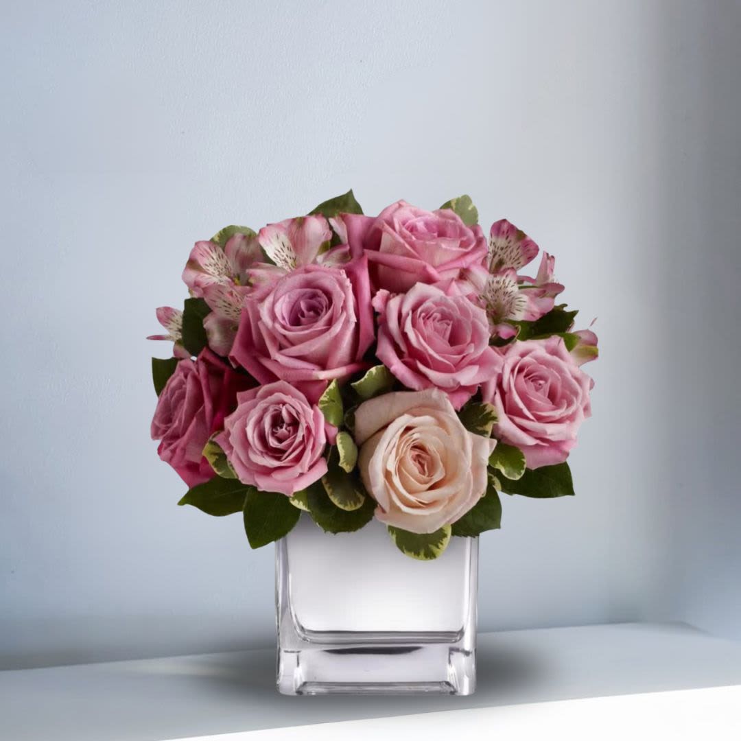 A Rosy Rendezvous - Understated yet spectacular, A Rosy Rendezvous is a gorgeous gift that she'll long remember. Recipe: This tastefully terrific bouquet features soft pink and lavender roses, along with alstromerias, in a sleek, contemporary cube vase.  Seasonal: All year round Design View: All Facing View Photo shown: Standard