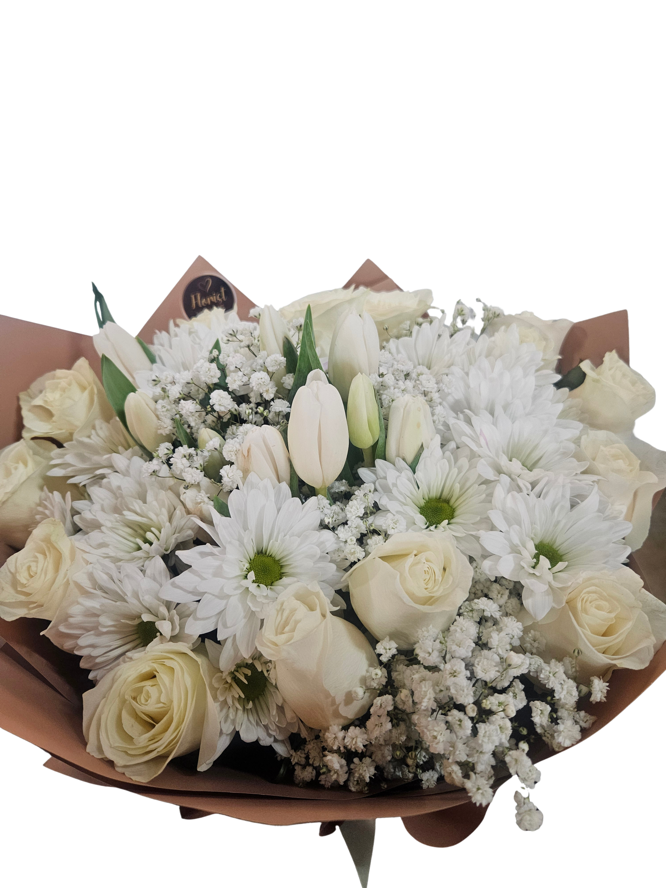 White roses and daisies with tulips in a wrapped bouquet