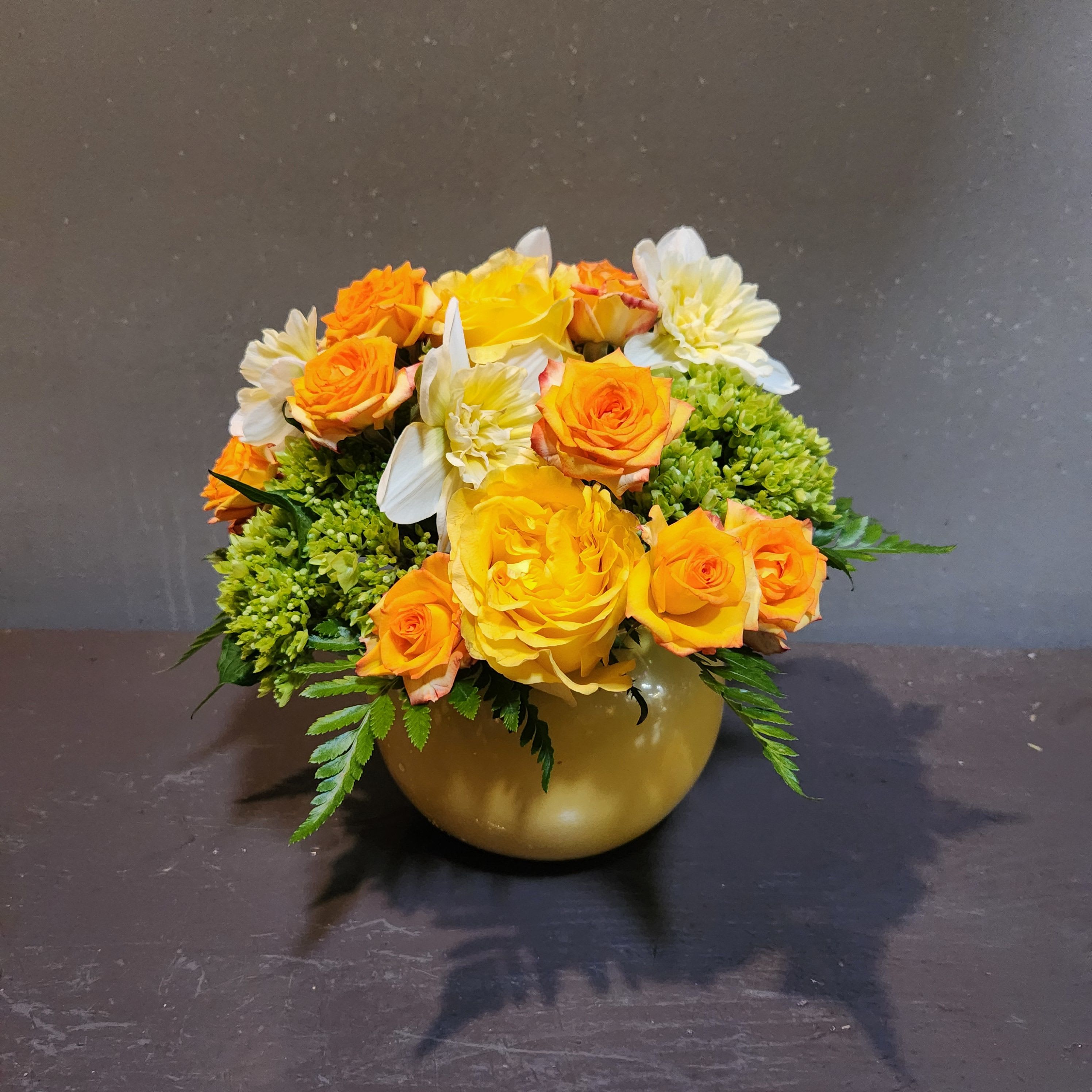 Sunshine In a Vase - This cheerful bouquet is filled with sunshine! Measures approx. 10"Tx9"W and arrives in a yellow glass vase.