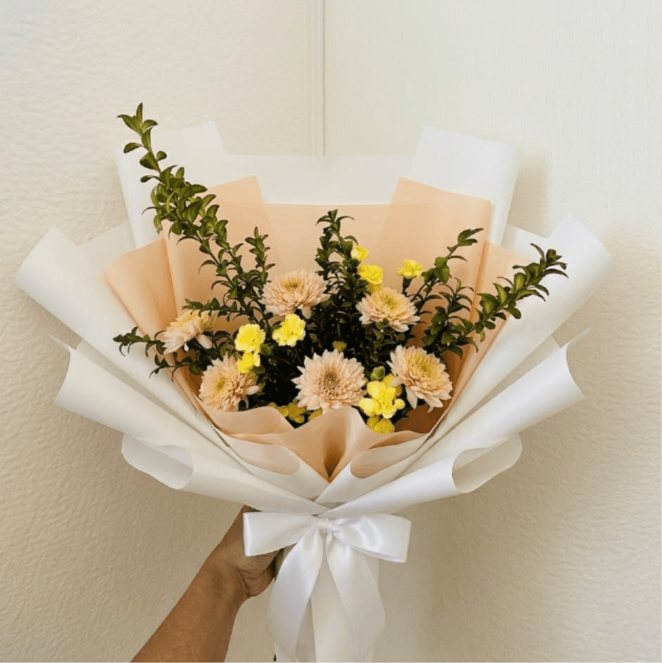 Citrus Squeeze - Zesty, refreshing, and bright—Citrus Squeeze brings a boost of energy to any birthday. The clean lines of yellow carnations and peach mums create a structured, cheerful look that feels both fun and modern.  This seasonal bouquet features:  Yellow Mini Carnations  Peach Mums  Fresh Boxwood  Garden Greens  Presentation: Expertly wrapped in our signature textured paper and tied with satin ribbon. Prefer a vase? Add one to your cart to complete the look.  Personal Touch: We’ll include a custom card message with every order. You’ll be able to write your message at checkout.  Please Note: All flowers are subject to seasonal availability. If a specific bloom isn’t available, our designers will thoughtfully substitute with flowers in a similar shape, style, and color.  Standard size shown. Vase upgrade is optional.   Floral Care Guide  Your arrangement arrives in our signature "double wrap" and is nestled in a protective box. While the stems are secured with a wet wrap for transit they are ready for a full drink!   Unpack: Gently lift the bouquet from the box. Remove the plastic bag and wet towel from the stems. Trim &amp; Hydrate: Trim 1/2" off stems at an angle and place in a clean vase with cool water. Refreshed: Change water daily for a long-lasting bloom.  