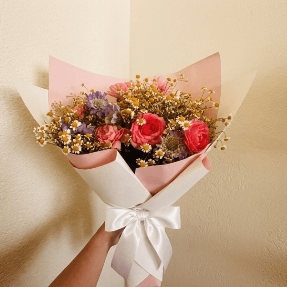 Confetti Blast - Exciting, diverse, and full of life—Confetti Blast is a floral explosion of color and texture. The mix of scabiosa, ranunculus, and feverfew creates a festive visual experience that is truly a party in a bouquet.  This seasonal bouquet features:  Lavender Scabiosa  Hot Pink Ranunculus  Petite White Feverfew  Garden Greens  Presentation: Expertly wrapped in our signature textured paper and tied with satin ribbon. Prefer a vase? Add one to your cart to complete the look.  Personal Touch: We’ll include a custom card message with every order. You’ll be able to write your message at checkout.  Please Note: All flowers are subject to seasonal availability. If a specific bloom isn’t available, our designers will thoughtfully substitute with flowers in a similar shape, style, and color.  Standard size shown. Vase upgrade is optional.   Floral Care Guide  Your arrangement arrives in our signature "double wrap" and is nestled in a protective box. While the stems are secured with a wet wrap for transit they are ready for a full drink!   Unpack: Gently lift the bouquet from the box. Remove the plastic bag and wet towel from the stems. Trim &amp; Hydrate: Trim 1/2" off stems at an angle and place in a clean vase with cool water. Refreshed: Change water daily for a long-lasting bloom.  