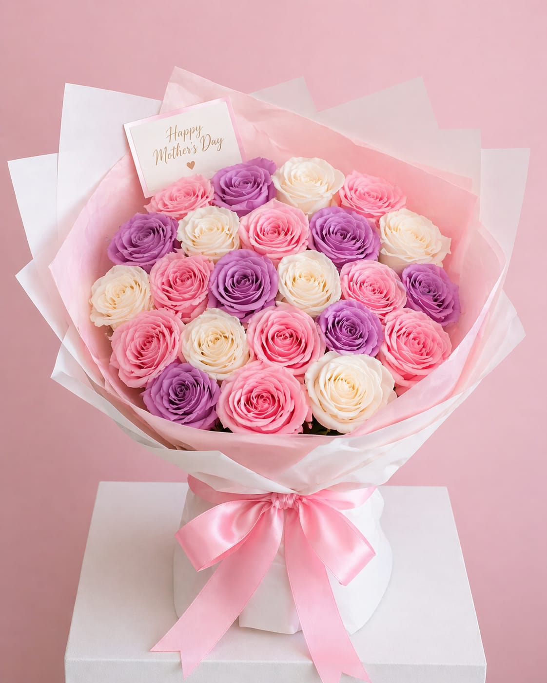 25 Multicolor Mom Bouquet - Make her feel truly special with our Blush Garden 50 Rose Bouquet, a luxurious arrangement designed to impress. This stunning bouquet features 50 fresh roses in a delicate blend of soft pink, ivory, and lavender tones, creating a romantic and elegant color palette perfect for Mother’s Day.  Handcrafted in a full, round style and wrapped in premium white and blush paper with a satin ribbon, this bouquet is both timeless and eye-catching. Whether you’re celebrating Mom, a loved one, or a meaningful moment, this design speaks with beauty, softness, and love.  Includes 25-50 roses. Rose tones may vary slightly based on availability. Fresh flowers.