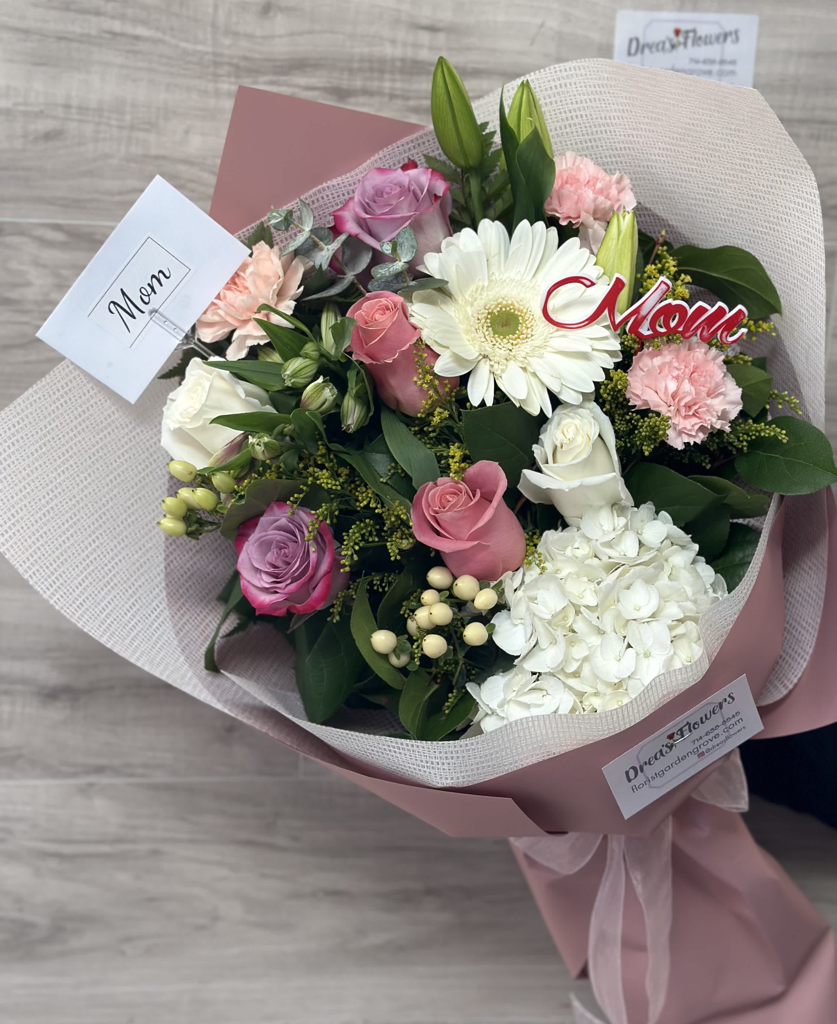 Bouquet of pink and white flowers wrapped in blush paper