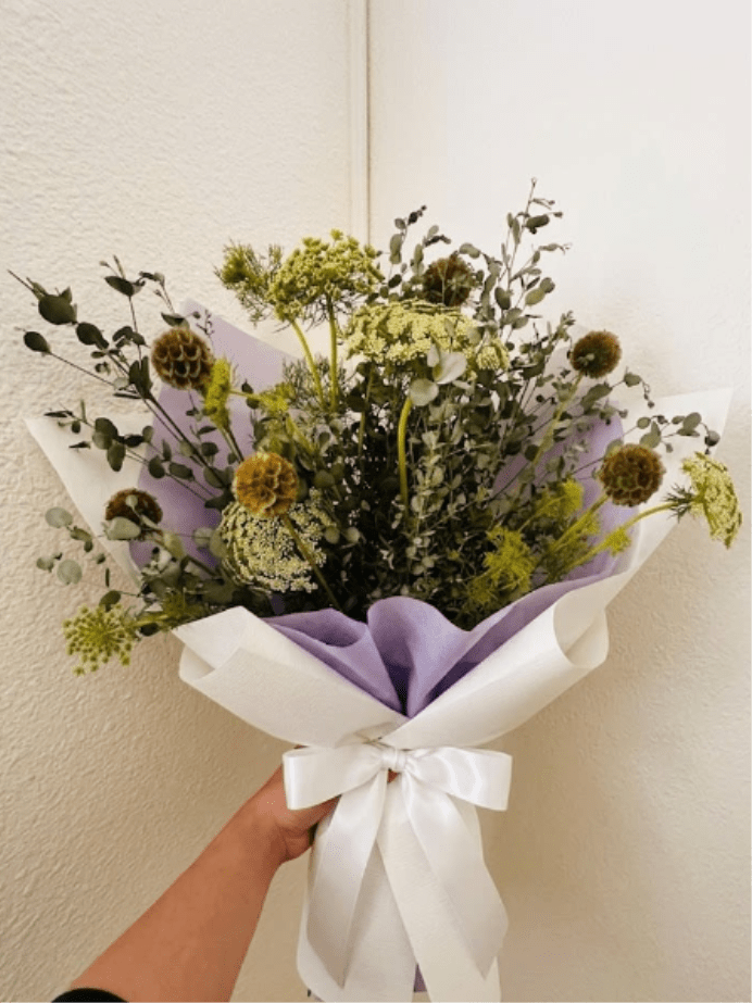 Soft Shadows - Understated, elegant, and textural—Soft Shadows focuses on the subtle beauty of monochromatic tones. The pairing of earthy scabiosa and delicate Queen Anne’s Lace is a quiet, sophisticated way to say "I'm sorry for your loss."  This seasonal bouquet features:  Brown Scabiosa Pods  Queen Anne’s Lace  Silvery Gunni Eucalyptus  Garden Greens  Presentation: Expertly wrapped in our signature textured paper and tied with satin ribbon. Prefer a vase? Add one to your cart to complete the look.  Personal Touch: We’ll include a custom card message with every order. You’ll be able to write your message at checkout.  Please Note: All flowers are subject to seasonal availability. If a specific bloom isn’t available, our designers will thoughtfully substitute with flowers in a similar shape, style, and color.  Standard size shown. Vase upgrade is optional.   Floral Care Guide  Your arrangement arrives in our signature "double wrap" and is nestled in a protective box. While the stems are secured with a wet wrap for transit they are ready for a full drink!   Unpack: Gently lift the bouquet from the box. Remove the plastic bag and wet towel from the stems. Trim &amp; Hydrate: Trim 1/2" off stems at an angle and place in a clean vase with cool water. Refreshed: Change water daily for a long-lasting bloom.  