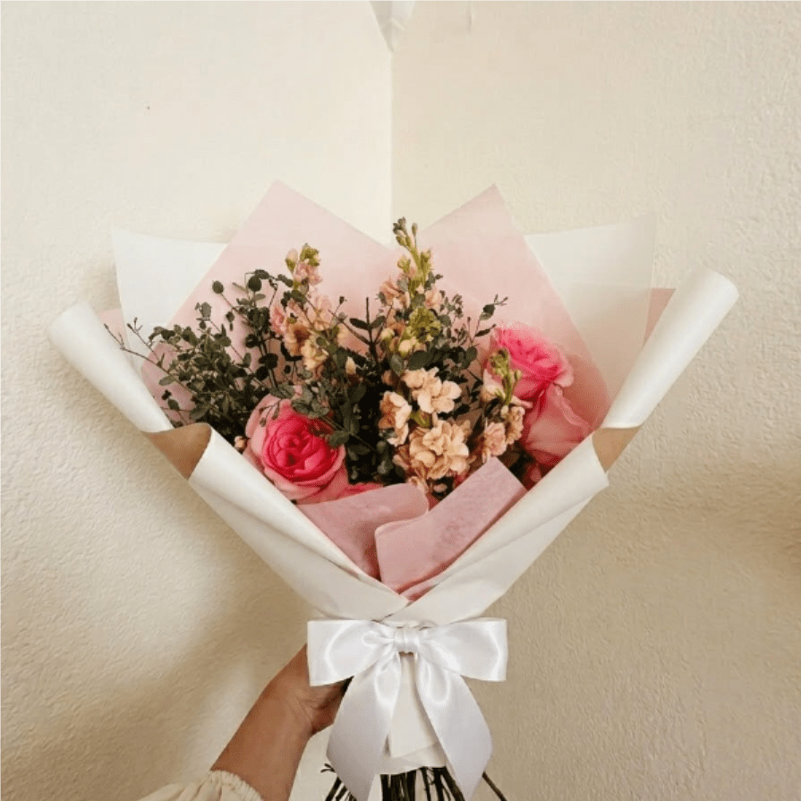 Gratitude - Warm, heartfelt, and timeless—Gratitude is a classic way to show someone they are valued. The beauty of pink roses and fragrant peach stock creates an inviting palette that speaks of deep appreciation and grace.  This seasonal bouquet features:  Premium Light Pink Roses  Peach Stock  Silvery Gunni Eucalyptus  Garden Greens  Presentation: Expertly wrapped in our signature textured paper and tied with satin ribbon. Prefer a vase? Add one to your cart to complete the look.  Personal Touch: We’ll include a custom card message with every order. You’ll be able to write your message at checkout.  Please Note: All flowers are subject to seasonal availability. If a specific bloom isn’t available, our designers will thoughtfully substitute with flowers in a similar shape, style, and color.  Standard size shown. Vase upgrade is optional.   Floral Care Guide  Your arrangement arrives in our signature "double wrap" and is nestled in a protective box. While the stems are secured with a wet wrap for transit they are ready for a full drink!   Unpack: Gently lift the bouquet from the box. Remove the plastic bag and wet towel from the stems. Trim &amp; Hydrate: Trim 1/2" off stems at an angle and place in a clean vase with cool water. Refreshed: Change water daily for a long-lasting bloom.  