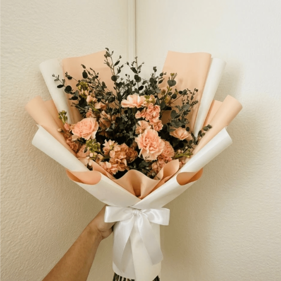 Little Peach - Creamy, warm, and welcoming—Little Peach is a sophisticated arrival gift for a cozy home. This gentle palette of stock and carnations is an elegant way to send your congratulations to a growing family.  This seasonal bouquet features:  Peach Stock  Peach Carnations  Silvery Gunni Eucalyptus  Garden Greens  Presentation: Expertly wrapped in our signature textured paper and tied with satin ribbon. Prefer a vase? Add one to your cart to complete the look.  Personal Touch: We’ll include a custom card message with every order. You’ll be able to write your message at checkout.  Please Note: All flowers are subject to seasonal availability. If a specific bloom isn’t available, our designers will thoughtfully substitute with flowers in a similar shape, style, and color.  Standard size shown. Vase upgrade is optional.   Floral Care Guide  Your arrangement arrives in our signature "double wrap" and is nestled in a protective box. While the stems are secured with a wet wrap for transit they are ready for a full drink!   Unpack: Gently lift the bouquet from the box. Remove the plastic bag and wet towel from the stems. Trim &amp; Hydrate: Trim 1/2" off stems at an angle and place in a clean vase with cool water. Refreshed: Change water daily for a long-lasting bloom.  