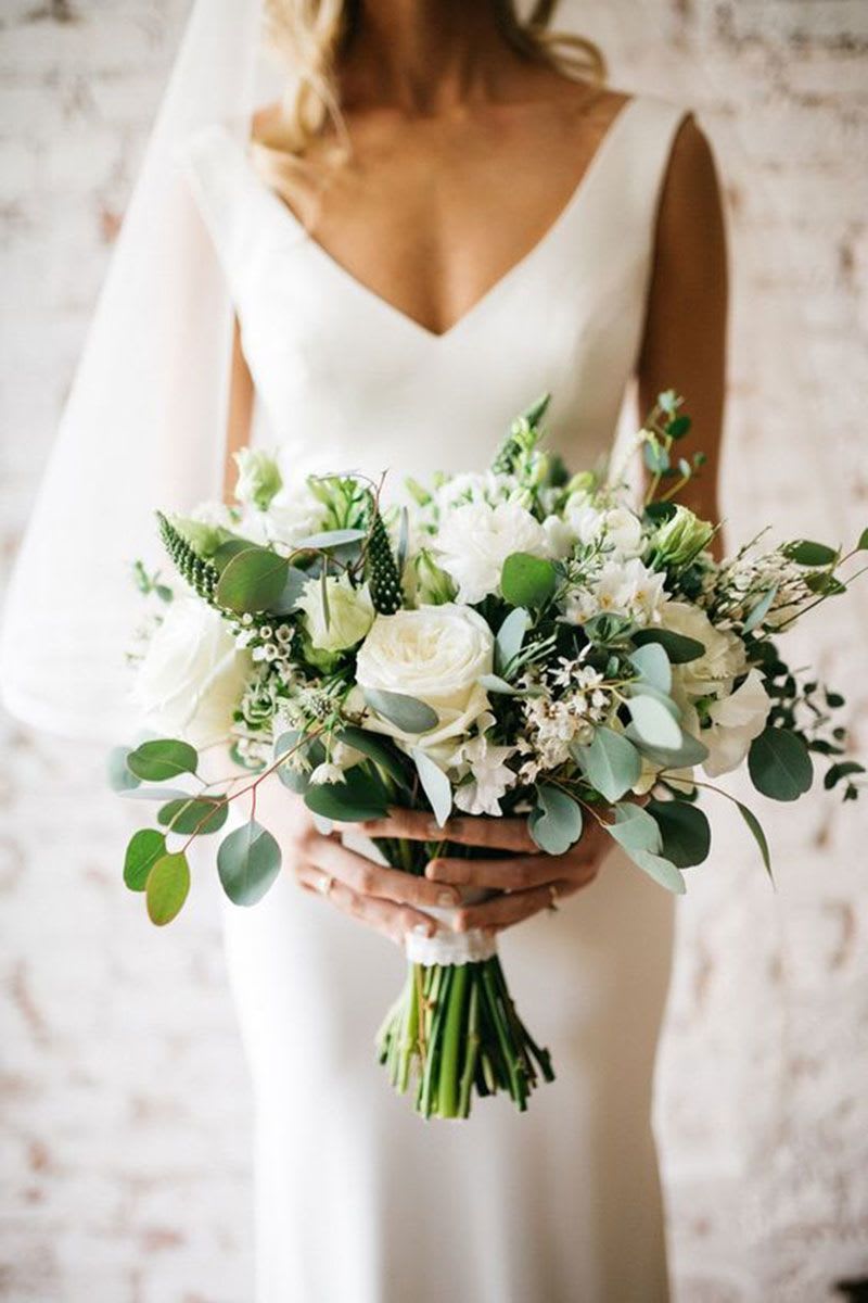 Timeless White Bridal Bouquet - A timeless and elegant bridal bouquet featuring premium white roses, delicate blooms, and soft eucalyptus greenery. Designed to complement a romantic and sophisticated wedding aesthetic, this bouquet brings a fresh, natural beauty to your special day. Each arrangement is handcrafted with care to ensure a luxurious and harmonious look.