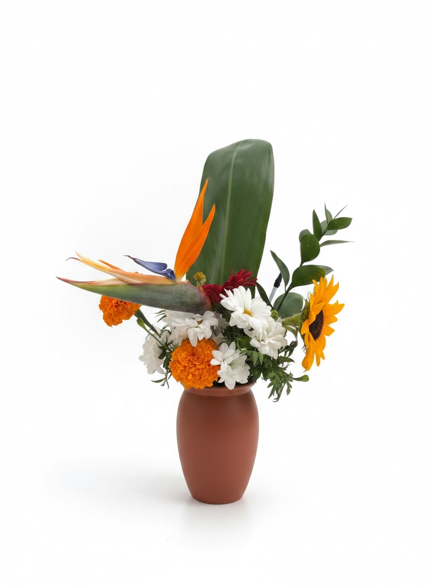 Tropical Bird - Sunrise Paradise is a vibrant, tropical-inspired arrangement featuring Bird of Paradise, sunflowers, marigolds, and white daisies with fresh greenery. Designed to bring warmth and joy, it’s perfect for celebrations, gifts, or brightening any space.