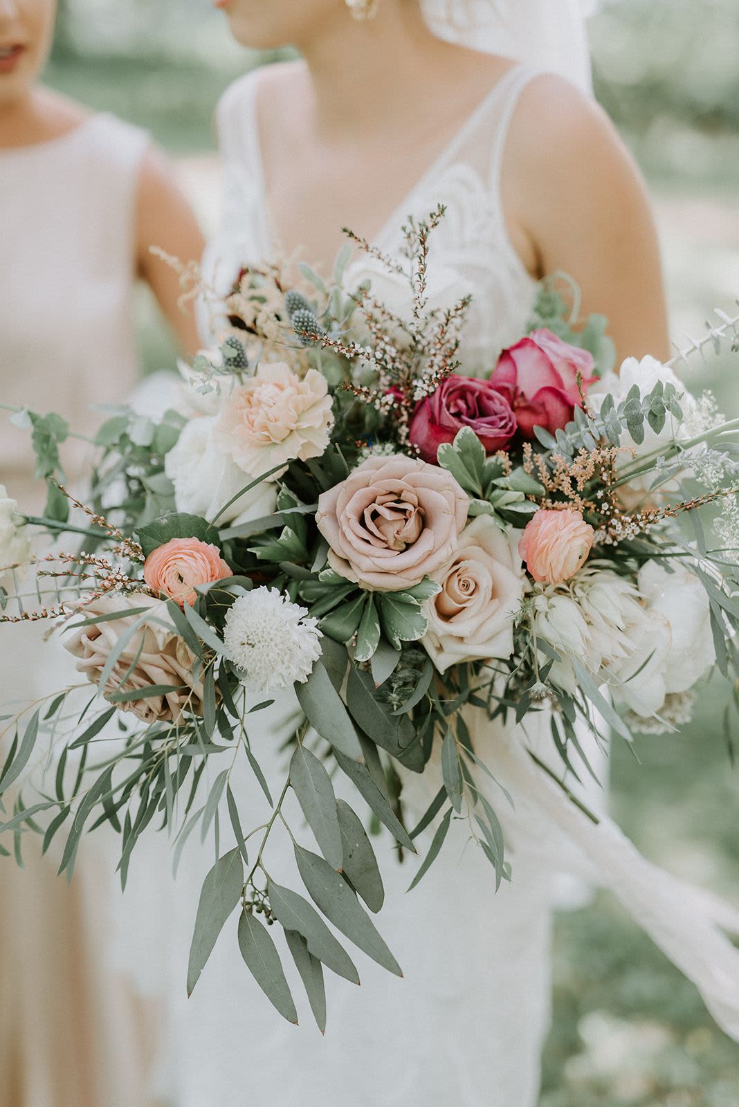 Romantic Blush Wedding Bouquet - A romantic garden-style bridal bouquet featuring soft blush roses, rich burgundy accents, delicate ranunculus, and airy eucalyptus greenery.  Designed with a natural, organic flow, this bouquet brings depth, texture, and elegance — perfect for modern and romantic weddings. Each arrangement is handcrafted to create a unique and sophisticated floral statement.
