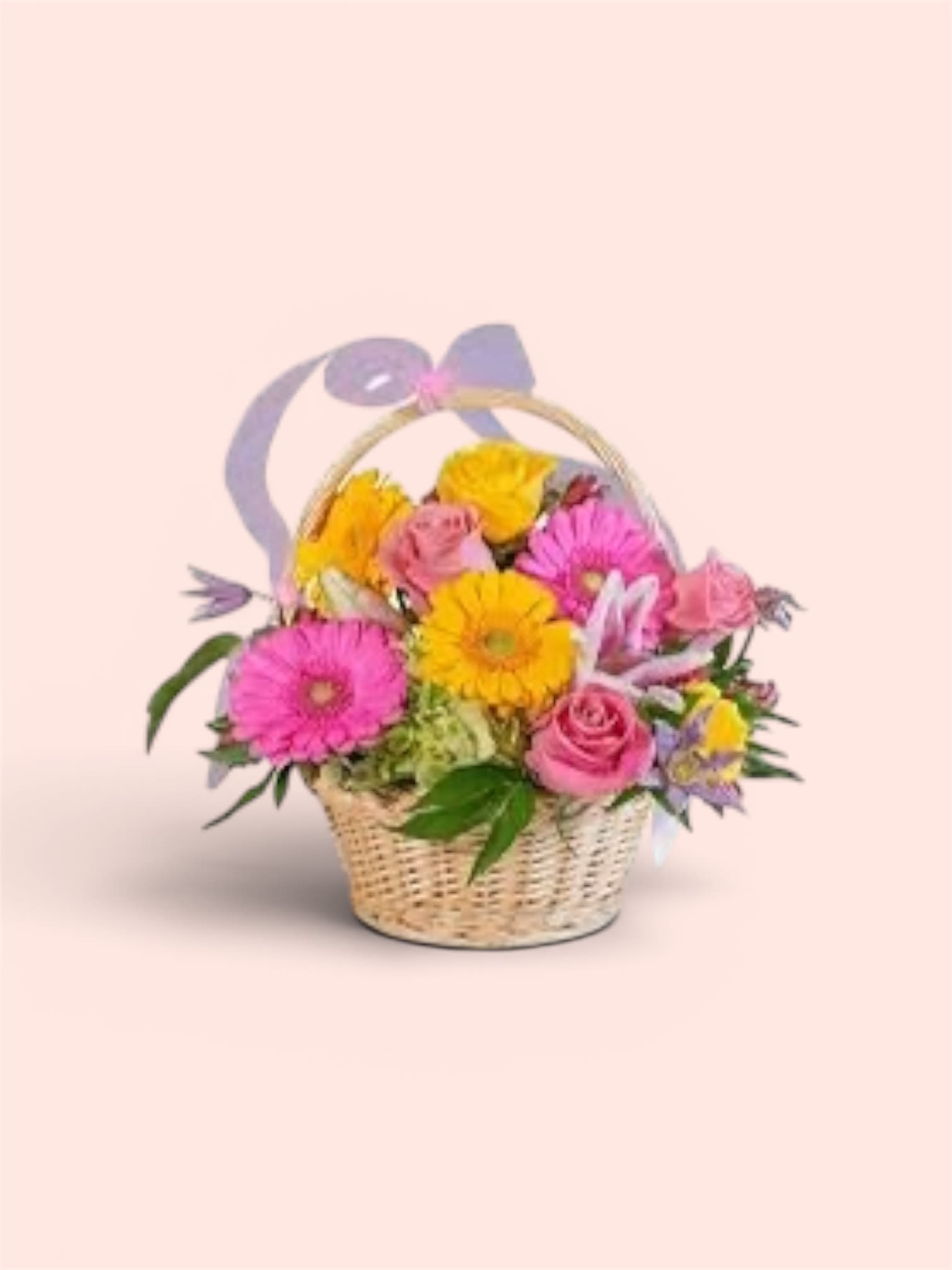 Mother’s Day Special #7 - Bright pink gerbera daisies and soft pink roses create an immediate burst of joy in this Mother's Day flower arrangement, perfect for celebrating Mom or sending springtime wishes. The woven basket and lavender ribbon bow give the bouquet a homespun, gift-ready feel that also suits Passover and Easter gatherings - the kind of arrangement that makes the person you're thinking of feel truly seen and celebrated.  Sunny yellow blooms and small lavender and white accent flowers tuck between the larger heads to add contrast, depth, and a light, airy touch. The mix of gerbera daisies, roses, and delicate fillers sits naturally in a low woven basket, arranged for a compact, table-friendly profile that works as a centerpiece or a bedside brightener. Colors: pink, yellow, purple, white; hard goods: woven basket with lavender ribbon bow.  Send this for a Mother's Day brunch, a spring birthday, or a cheerful get-well surprise - it reads fresh all season long. No-fuss care: keep in fresh water, trim stems every few days, and place away from direct heat to extend the life of the blooms.