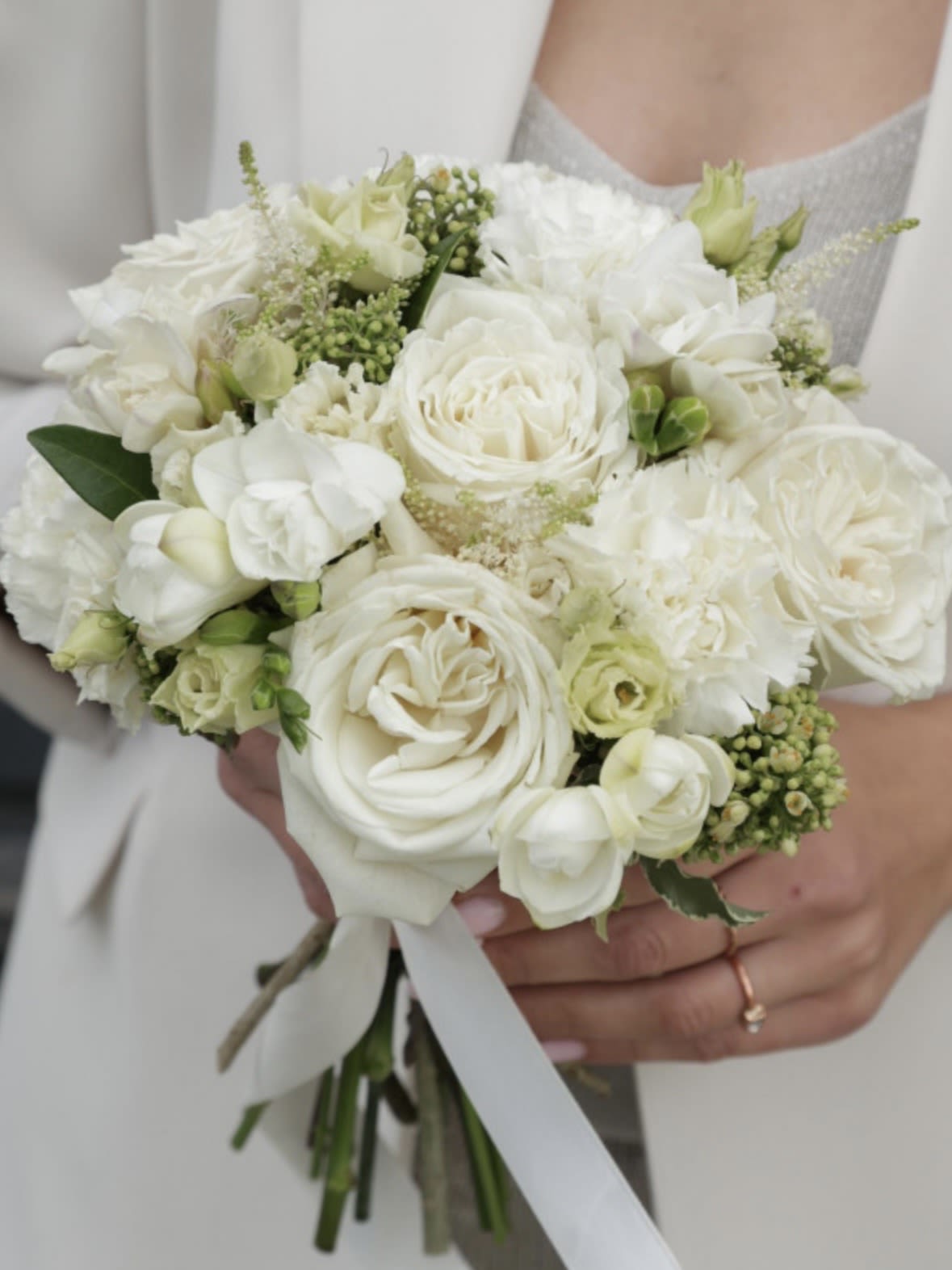 Luxury White Garden Bridal Bouquet - A luxurious and timeless bridal bouquet featuring premium white garden roses, delicate ranunculus, and soft seasonal blooms.  Designed with a refined and elegant style, this bouquet creates a full, romantic look with soft texture and natural movement. Perfect for classic and sophisticated weddings, each arrangement is handcrafted to deliver a graceful and polished finish.