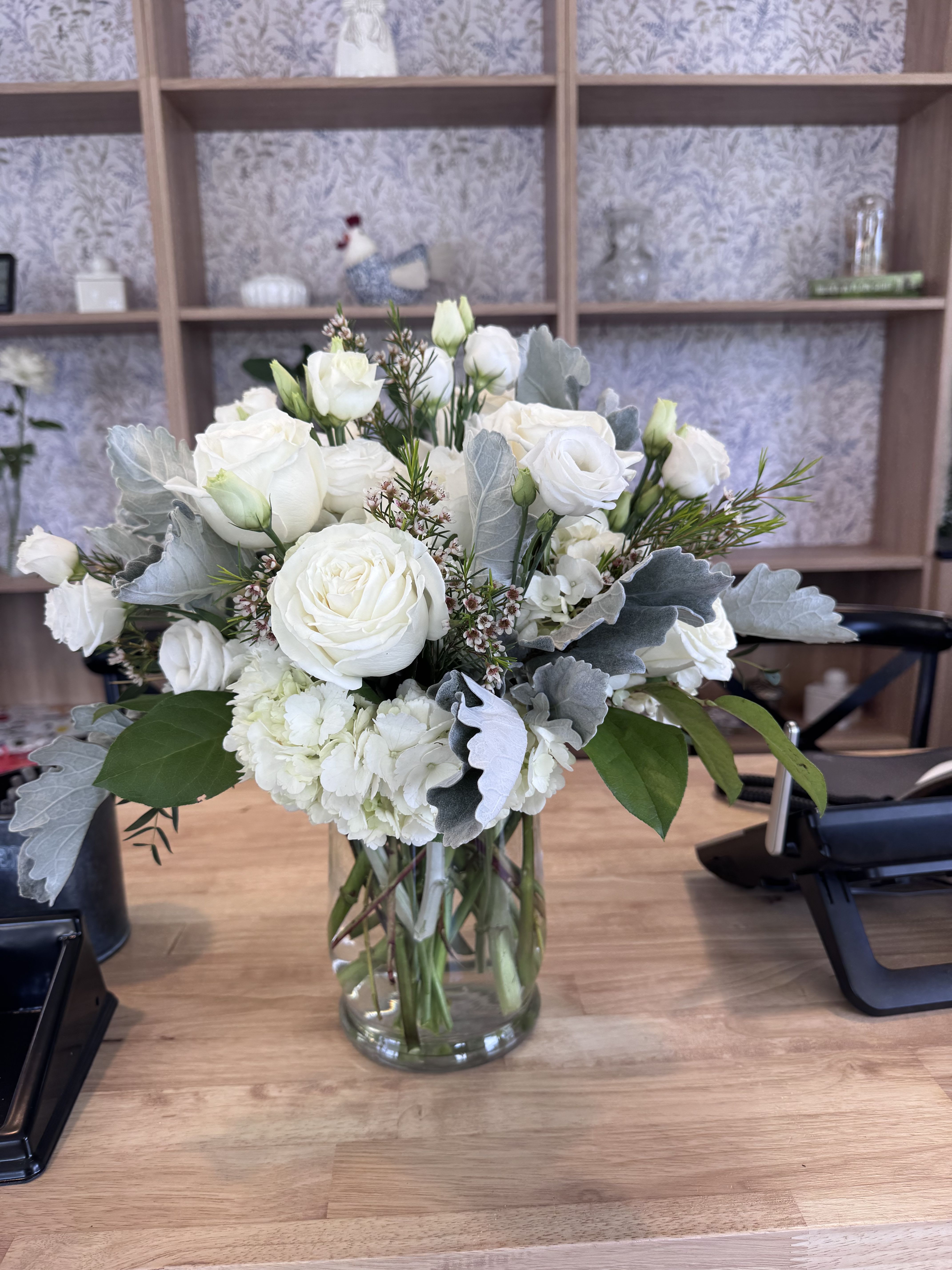 The Ivory Garden  - A lush mix of roses, spray roses, hydrangea, lisianthus, dusty miller and mixed greenery. 