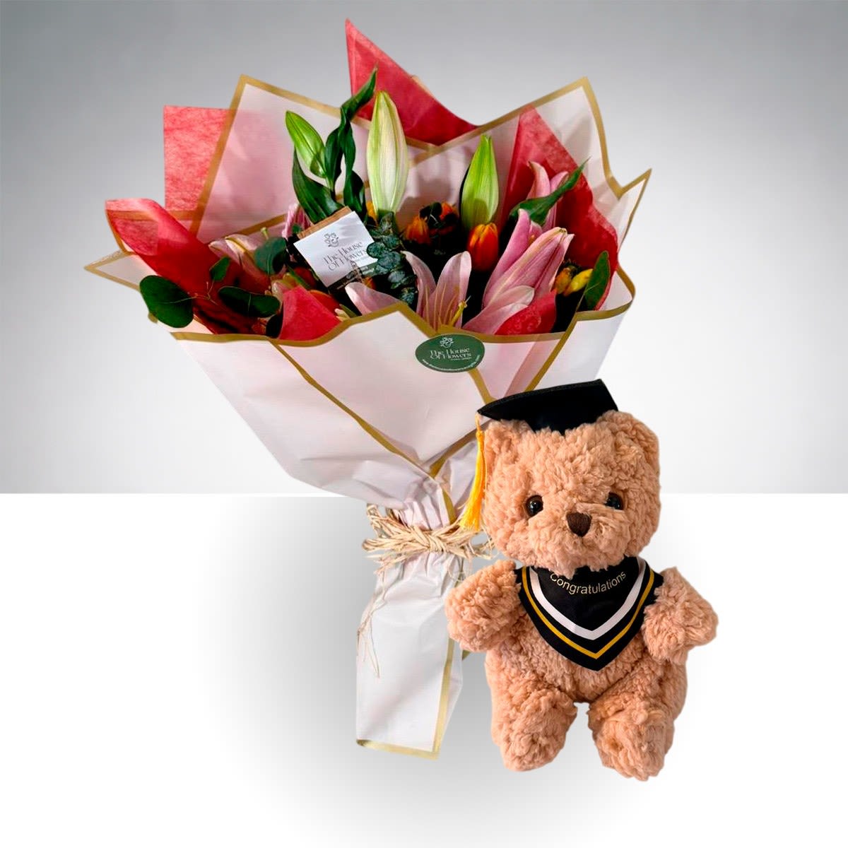 Blush Lily Graduation Bouquet with Teddy by The House of Flowers - Celebrate a special milestone with our Blush Lily Graduation Bouquet with Teddy, a fresh and elegant arrangement designed to brighten their big day. This hand-tied bouquet features beautiful pink lilies paired with seasonal blooms and lush greenery, all wrapped in a modern, stylish presentation.  Accompanied by a charming graduation teddy bear, this gift is the perfect combination of beauty and sentiment—ideal for congratulating your graduate in a memorable way.  Includes:  * Pink lilies * Seasonal accent flowers * Fresh greenery * Signature hand-wrapped bouquet * Graduation teddy bear  Perfect for graduations of all levels and a thoughtful way to say “Congratulations!” 