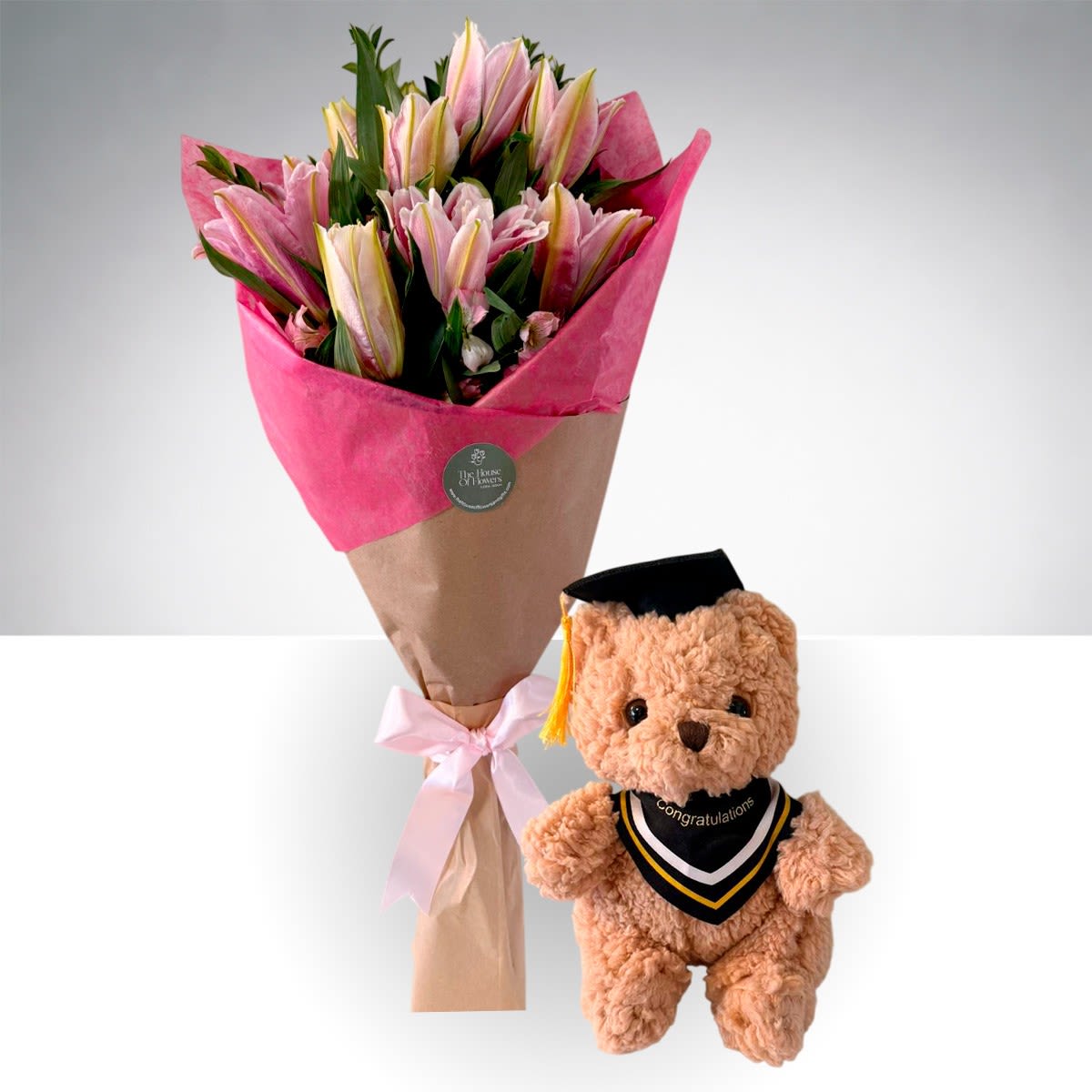 Sweet Graduation Lily Bouquet &amp; Teddy by The House of Flowers - Celebrate their big day with our Sweet Graduation Lily Bouquet &amp; Teddy, a fresh and cheerful gift designed to make any graduate smile. This hand-tied bouquet features beautiful pink lilies paired with seasonal accents and lush greenery, wrapped in our signature modern style.  Paired with a soft graduation teddy bear, this thoughtful gift is perfect for saying “Congratulations” in a sweet and memorable way. Includes:  * Pink lilies * Seasonal accent flowers * Fresh greenery * Signature hand-wrapped bouquet * Graduation teddy bear  Perfect for high school or college graduations. 