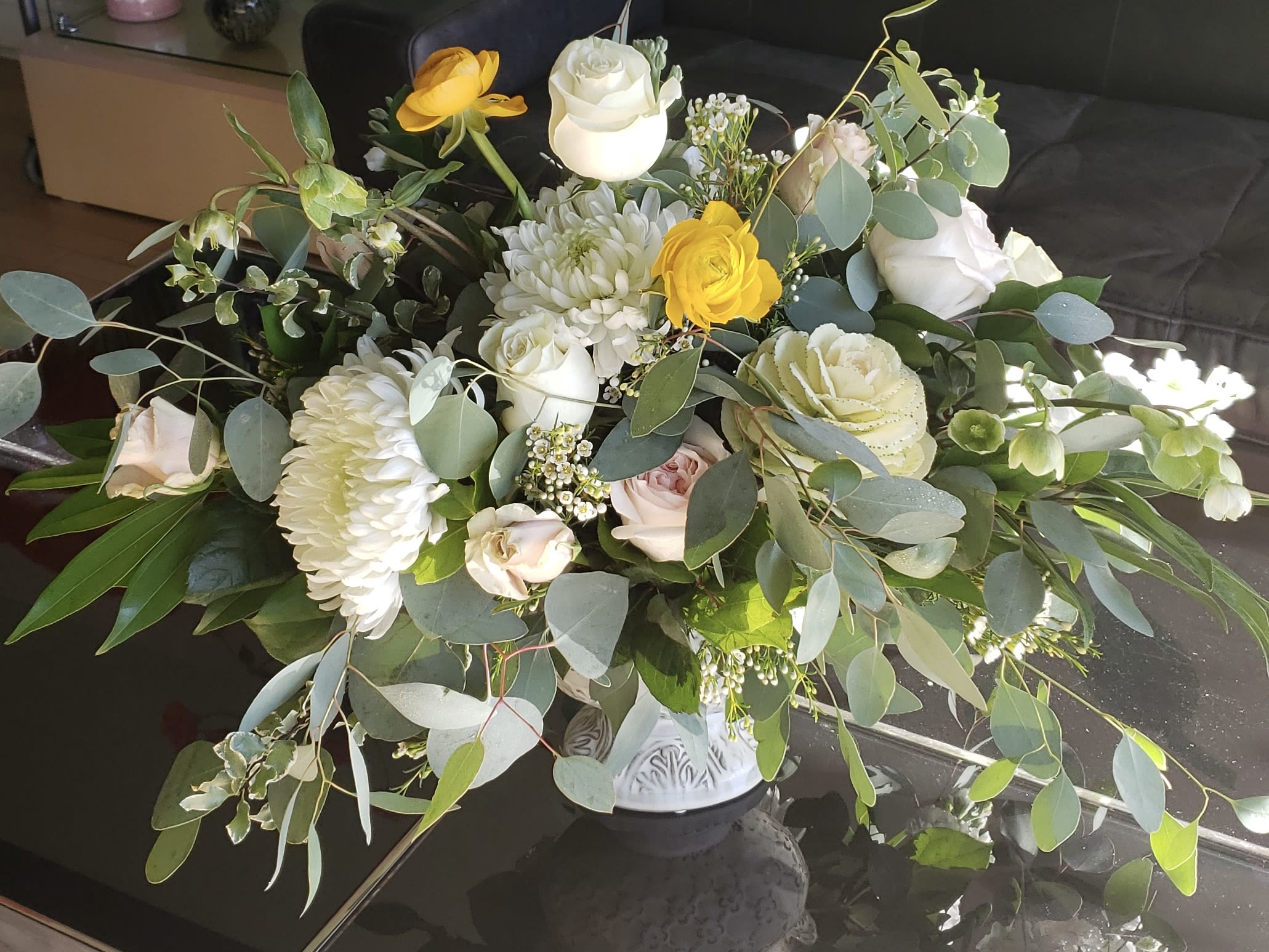 Garden Style Wedding Centerpiece - A fresh garden-style centerpiece featuring soft white blooms accented with seasonal greenery and delicate pops of color.  Designed to bring a natural and organic feel to your wedding tables, this arrangement adds movement, texture, and a relaxed elegance to your décor. Each piece is handcrafted to create a light and airy floral look.