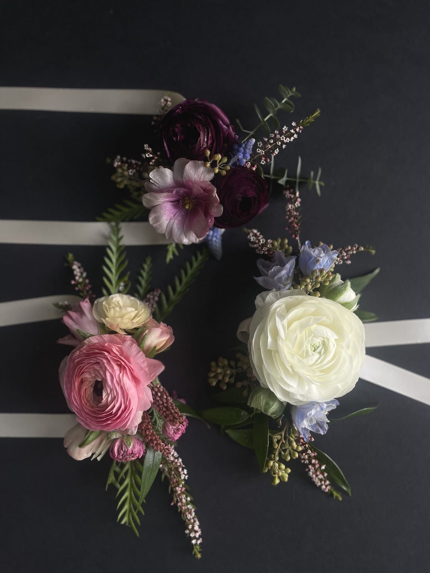 Wristlet Corsage - Corsages are a timeless symbol of tradition and elegance, serving as a beautiful accessory for a special occasion.   The elastic wristlet maintains a classic corsage style.  Please specify in the notes any color requests for flowers and ribbon color.  Corsages shown here are all just examples of options.  Your corsage will be custom-designed to be uniquely yours.