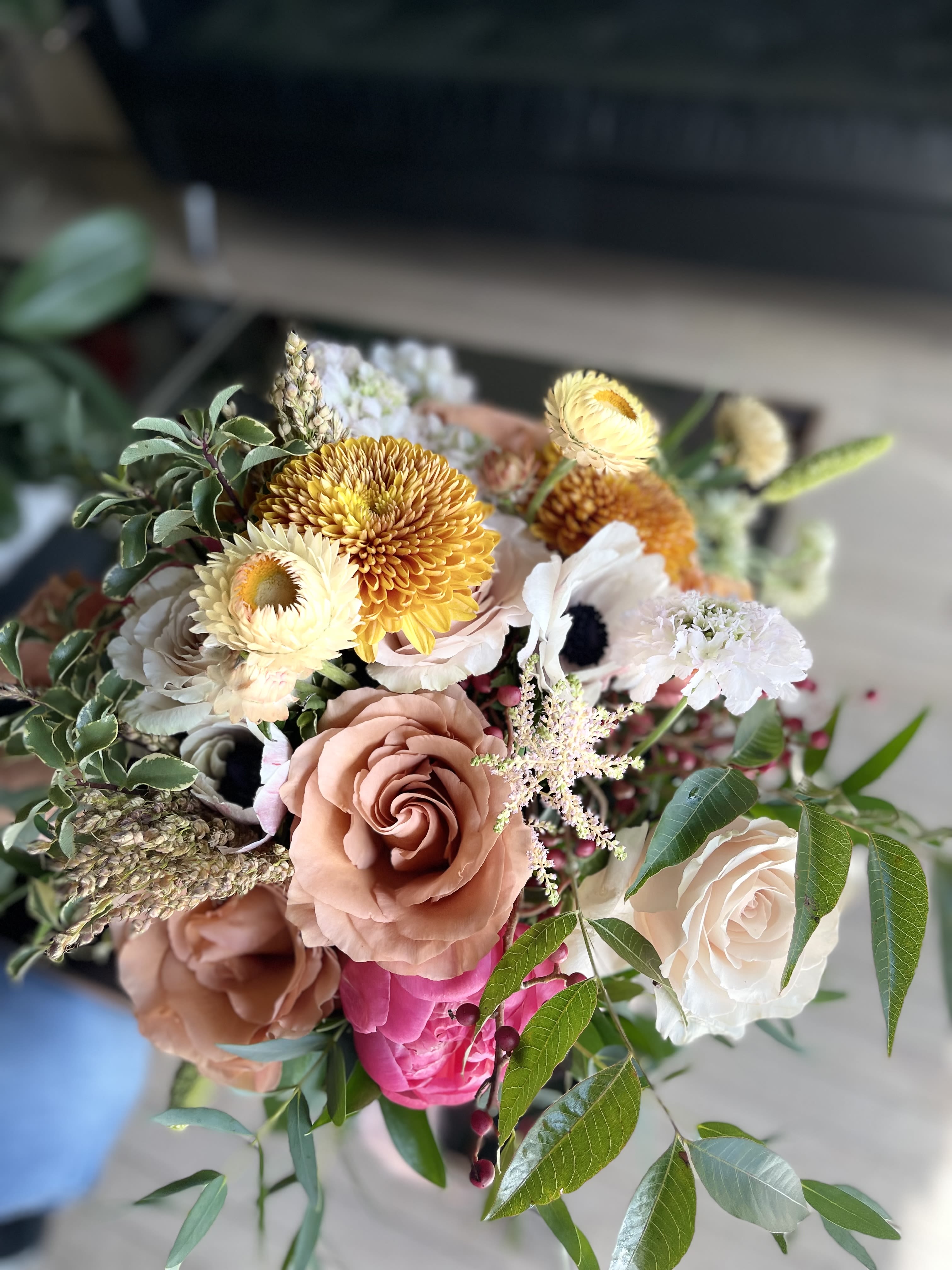 Golden Blush Bridal Bouquet - A luxurious garden-style bridal bouquet featuring warm blush roses, golden seasonal blooms, and lush greenery.  Designed with a natural, airy feel and rich texture, this bouquet brings warmth, elegance, and a romantic autumn touch to your wedding day.  Perfect for modern, boho, or classic weddings, it creates a soft yet statement look that photographs beautifully.  Each bouquet is handcrafted and may vary slightly while maintaining the same color palette and overall style.