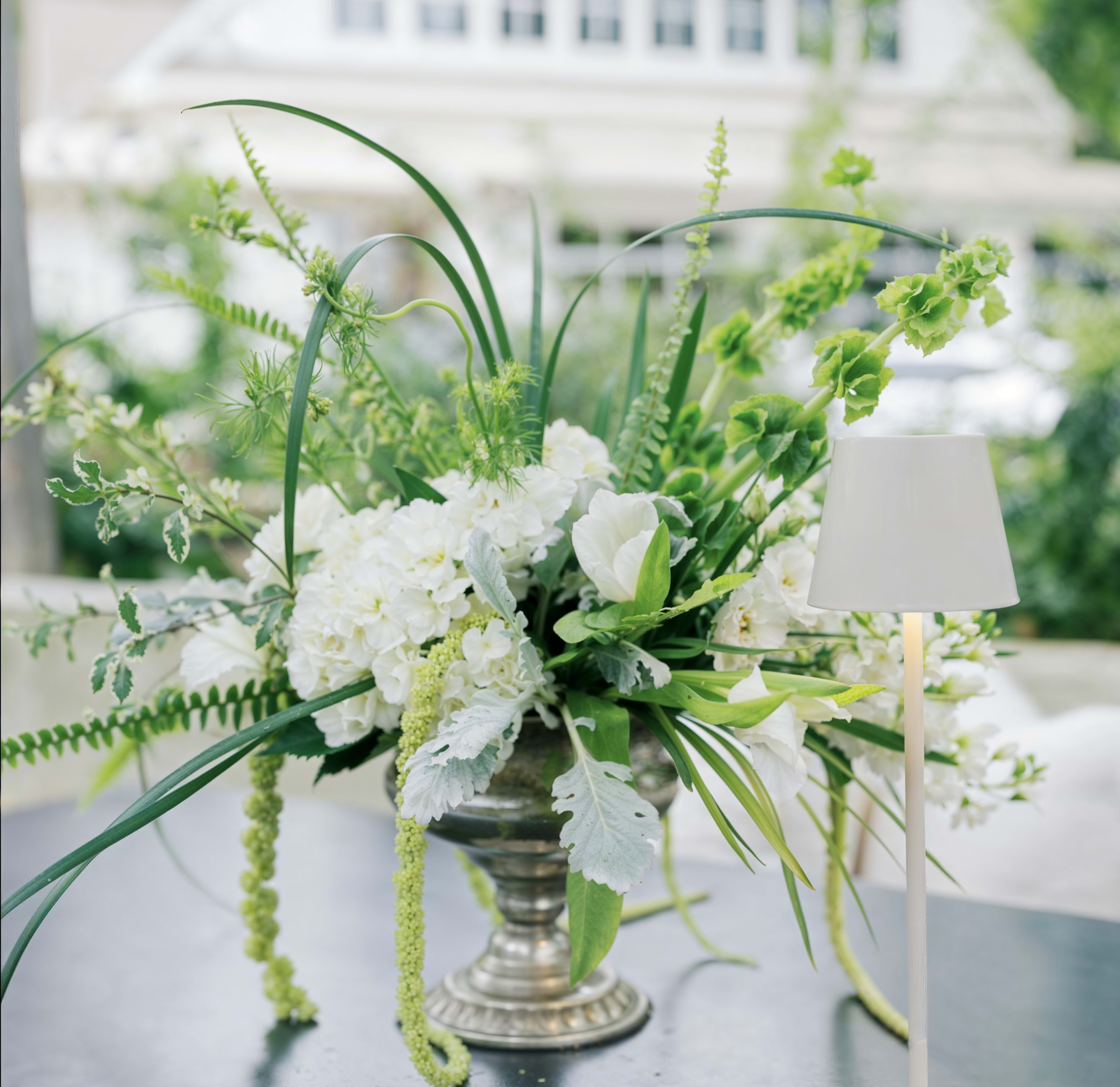 Modern Garden Centerpiece  - A modern garden-style centerpiece featuring airy greenery, soft white blooms, and an organic, asymmetrical design.  This arrangement brings a fresh, natural feel to any table, combining movement, texture, and elegance in a contemporary style.  Perfect for weddings, events, or sophisticated everyday décor.  Each arrangement is handcrafted and may vary slightly while maintaining the same overall look and color palette.