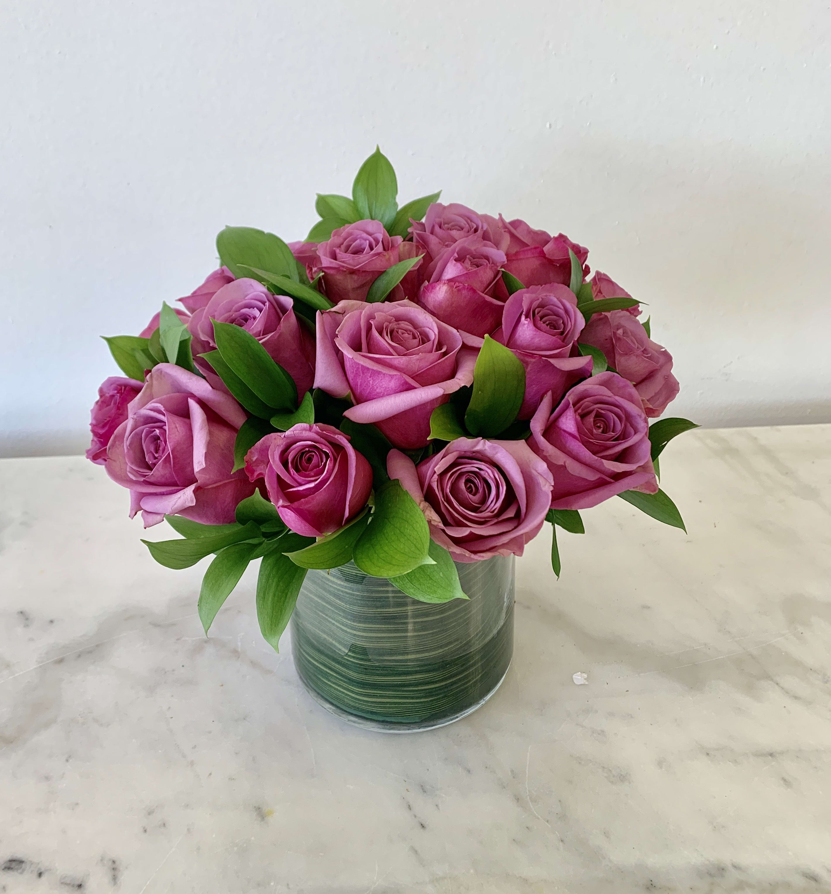 Pink roses arranged in a clear glass vase