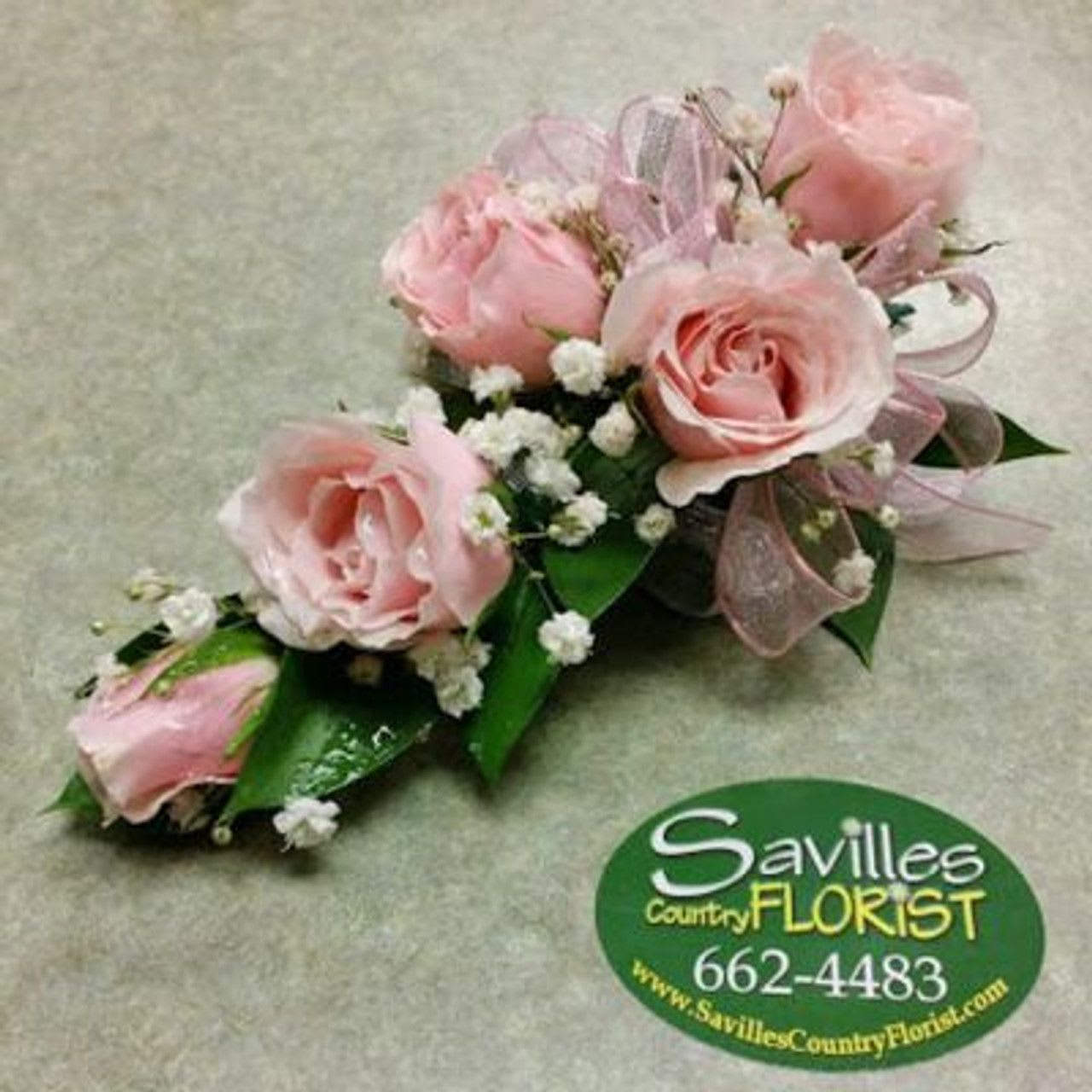 Pink rose corsage with baby's breath and ribbon