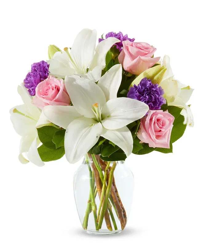 Spring into Pastels Mother's Day special! - Abound with white lilies, pink roses and purple carnations our Perfect in Pastel Bouquet is the perfect gift to show how much you care. White lilies symbolize devotion and humility, pink roses symbolize elegance and grace, while purple carnations symbolize royalty and loyalty! Send these fresh flowers to someone special and they will certainly speak for themselves!  Includes: • One dozen Pink Roses • Purple assorted flowers • White Lilies • Glass Vase • Personalized Card Message