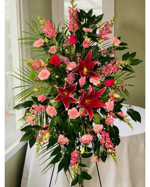 Tall floral spray with red lilies and pink carnations